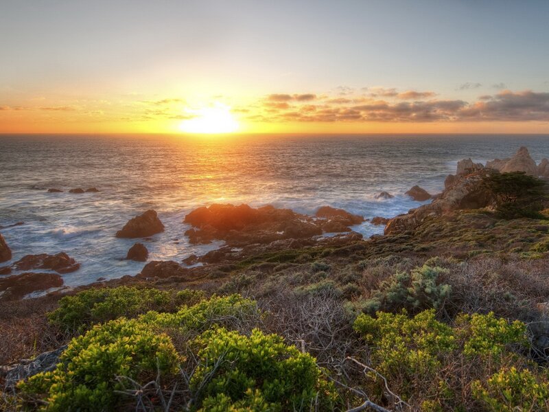 Sunset over rocky coastline