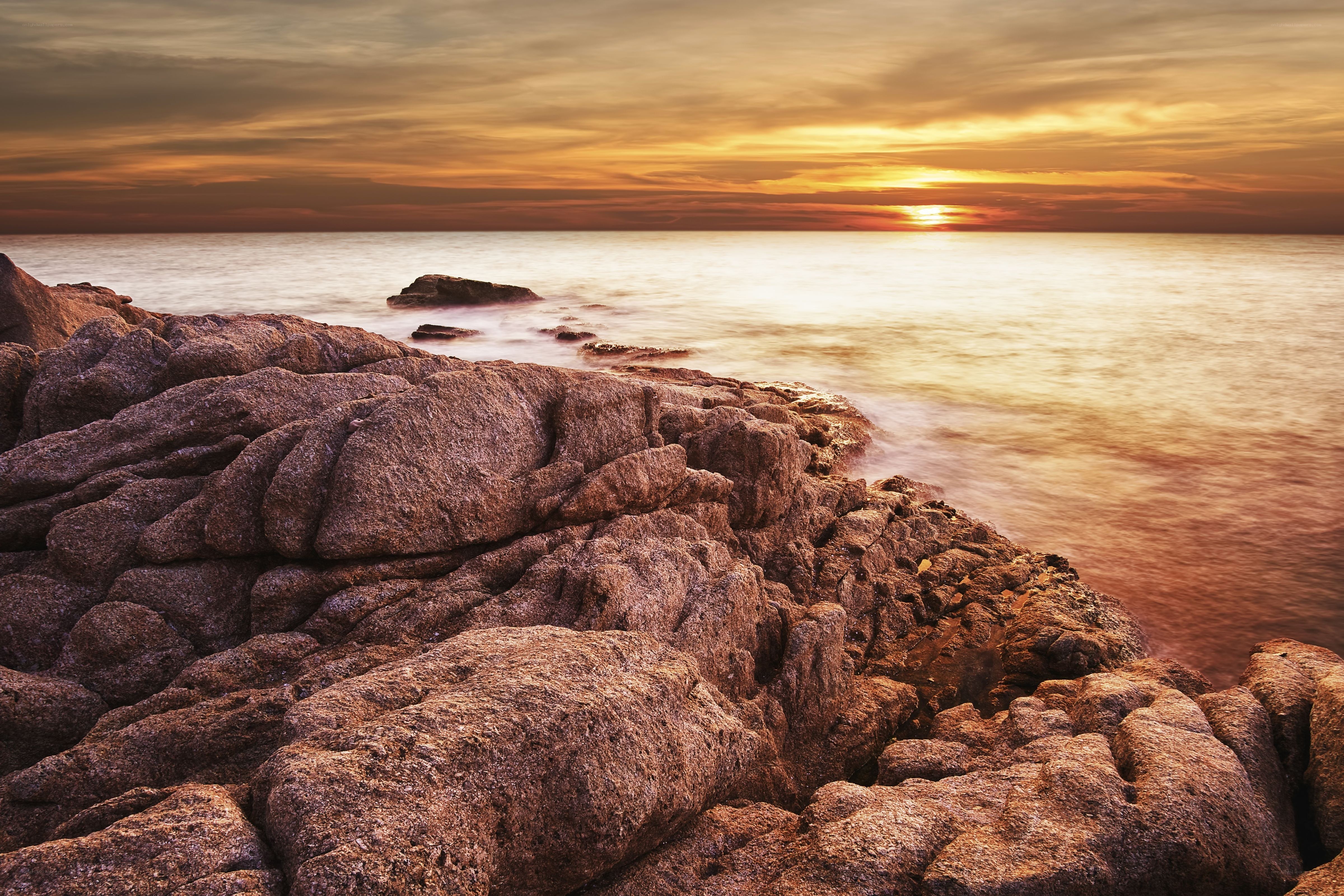 Sunset over rocky coastline