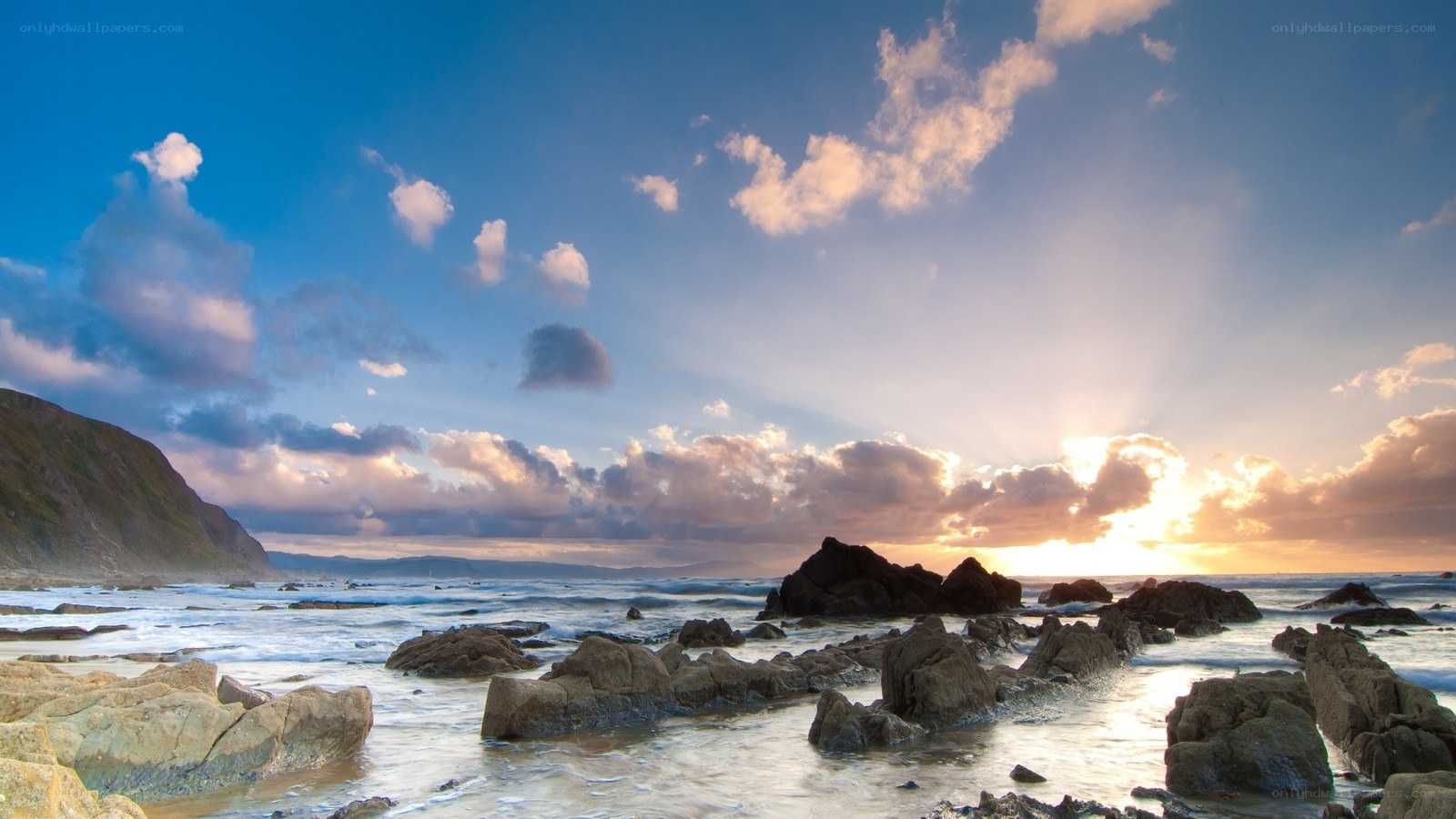 Sunset over rocky coastline