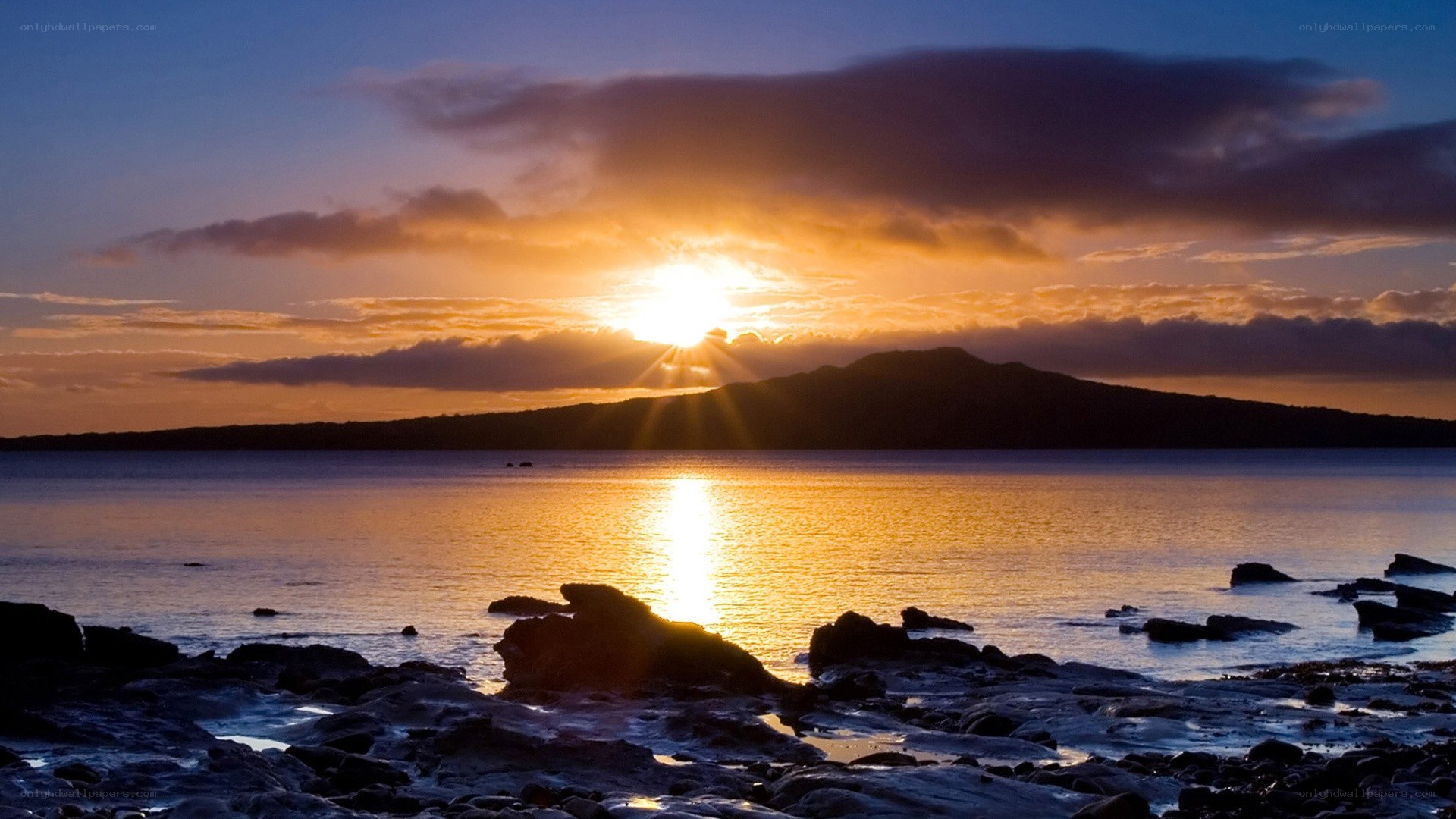 Sunset over rocky coastline
