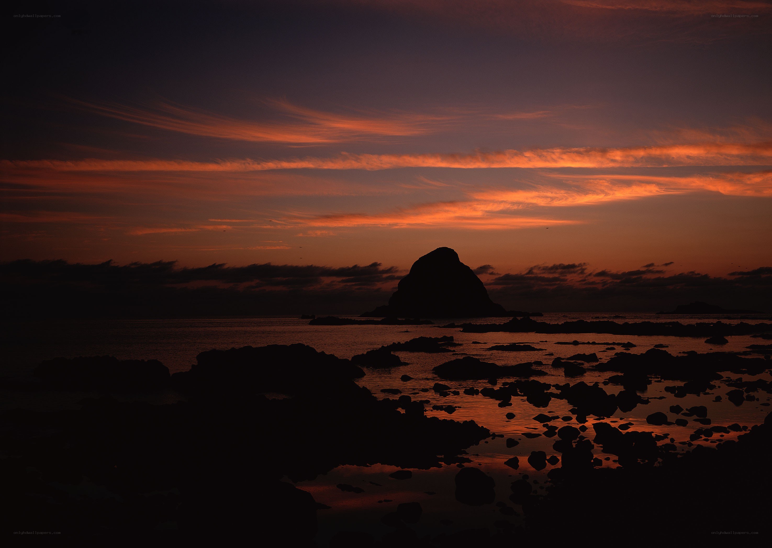 Sunset over rocky coastline