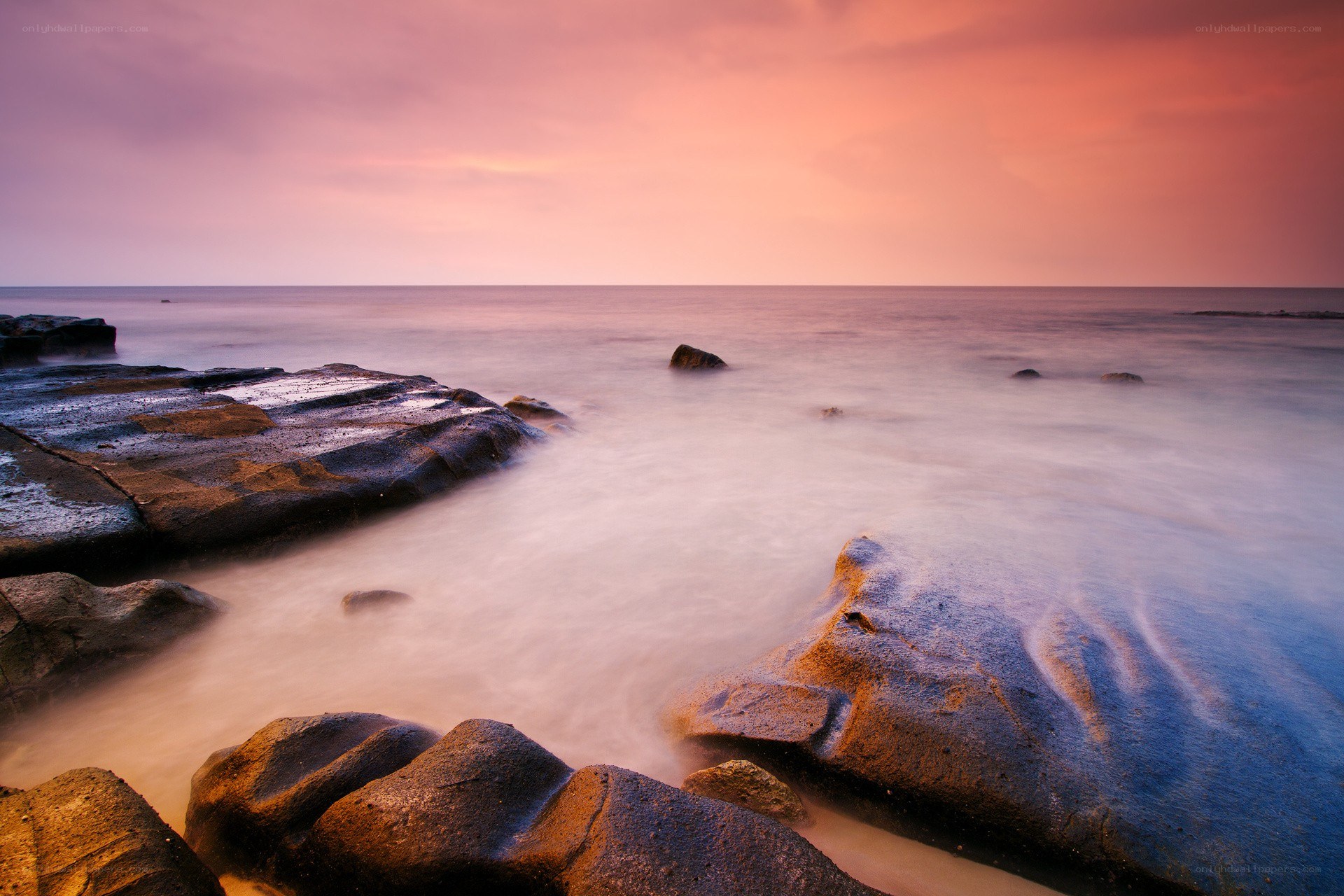 Sunset over rocky coastline