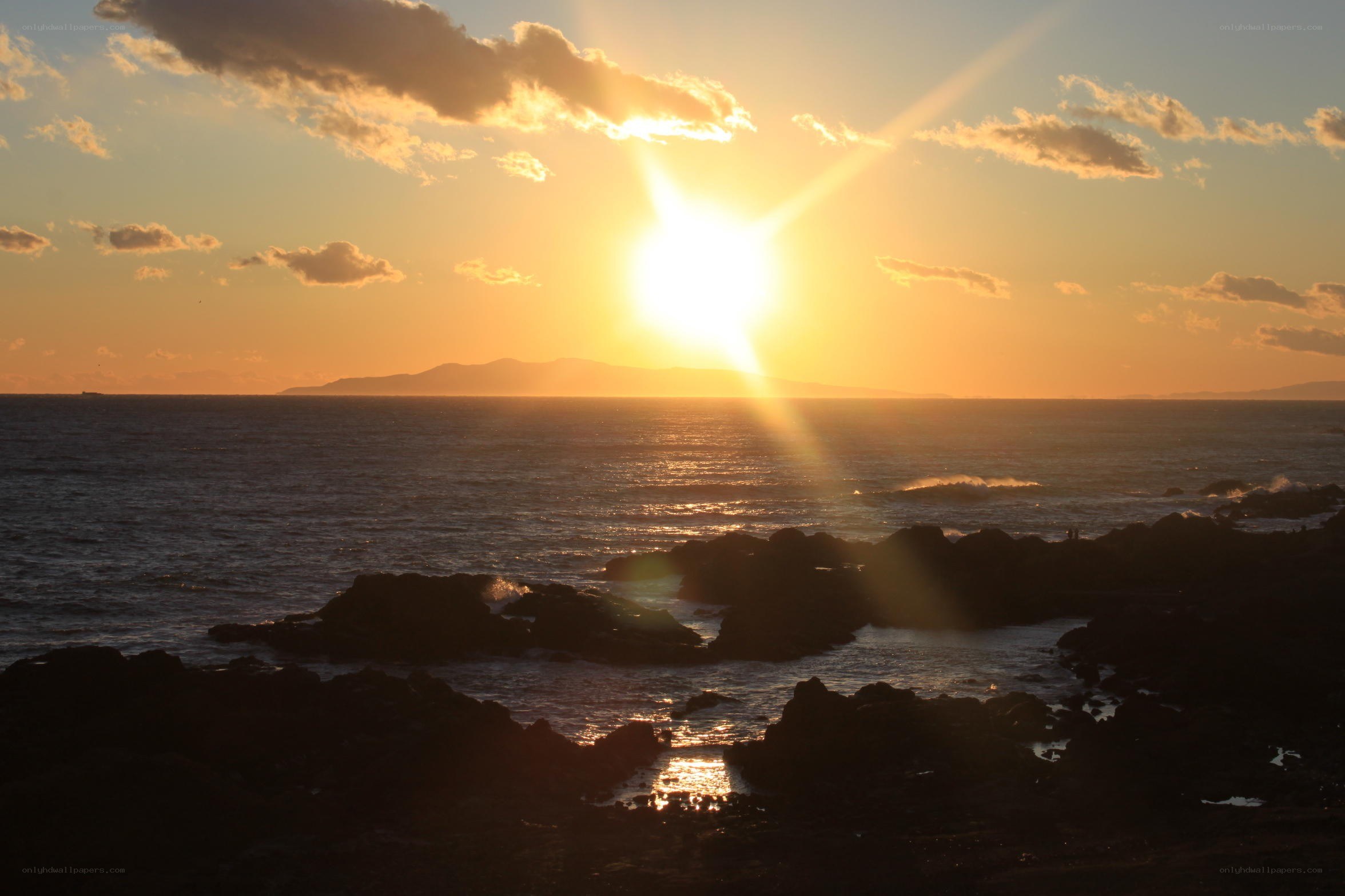 Sunset over rocky coastline