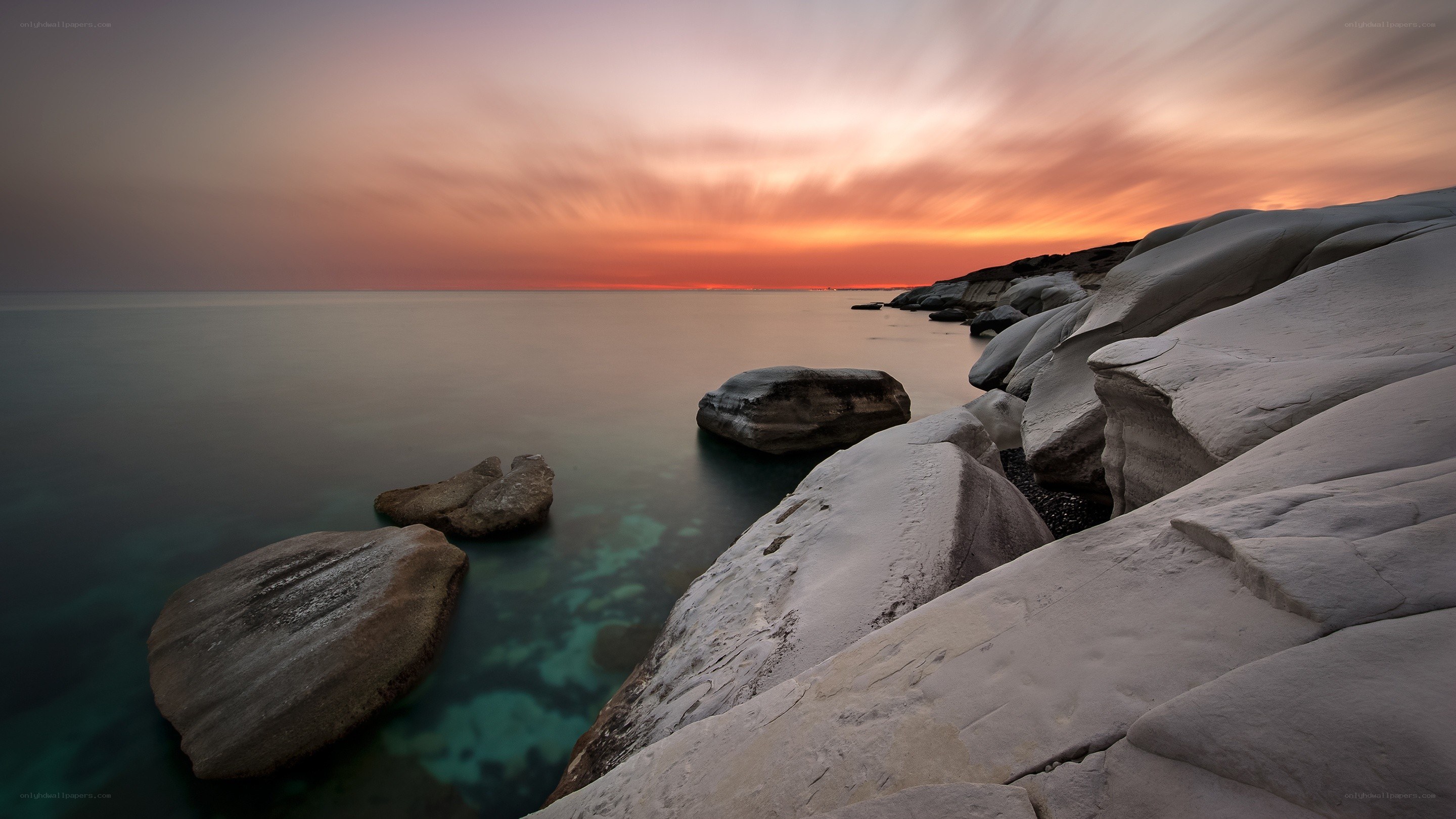 Sunset over rocky coastline