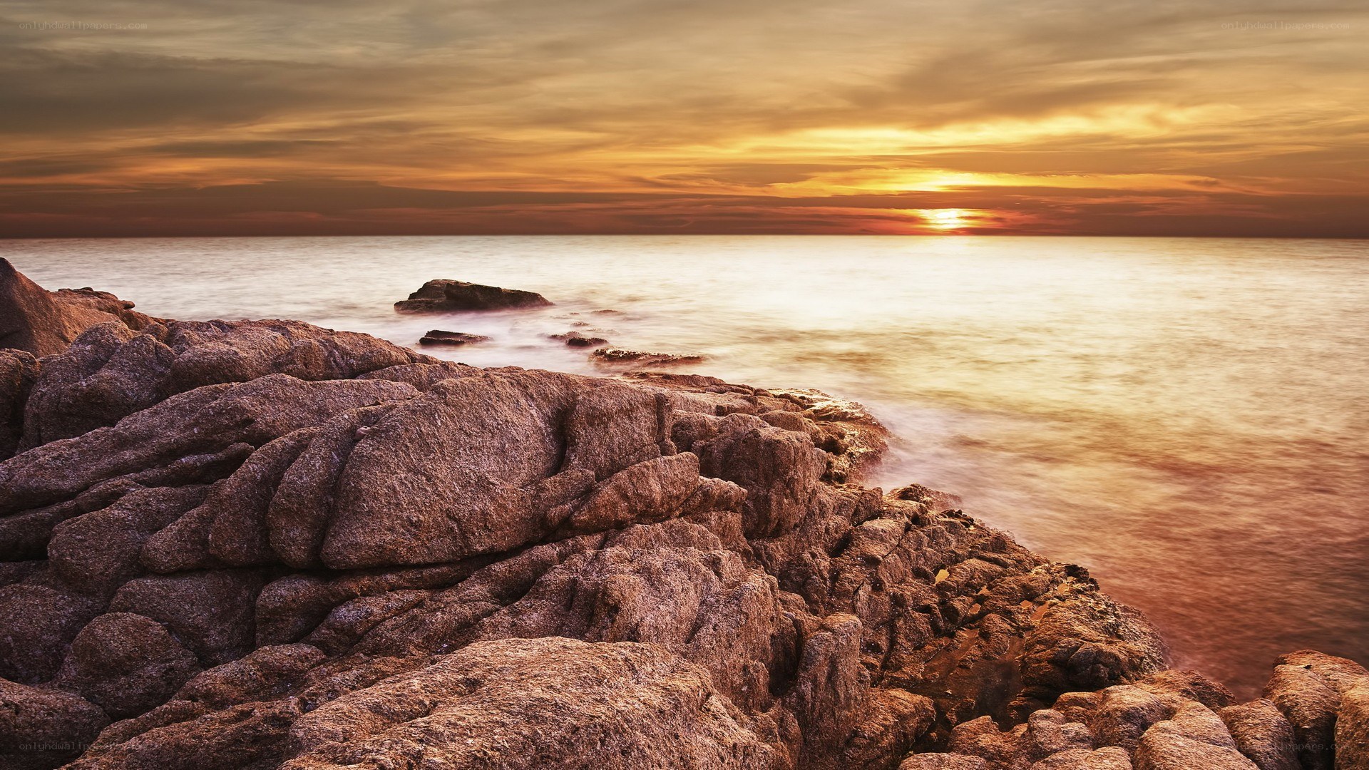 Sunset over rocky coastline