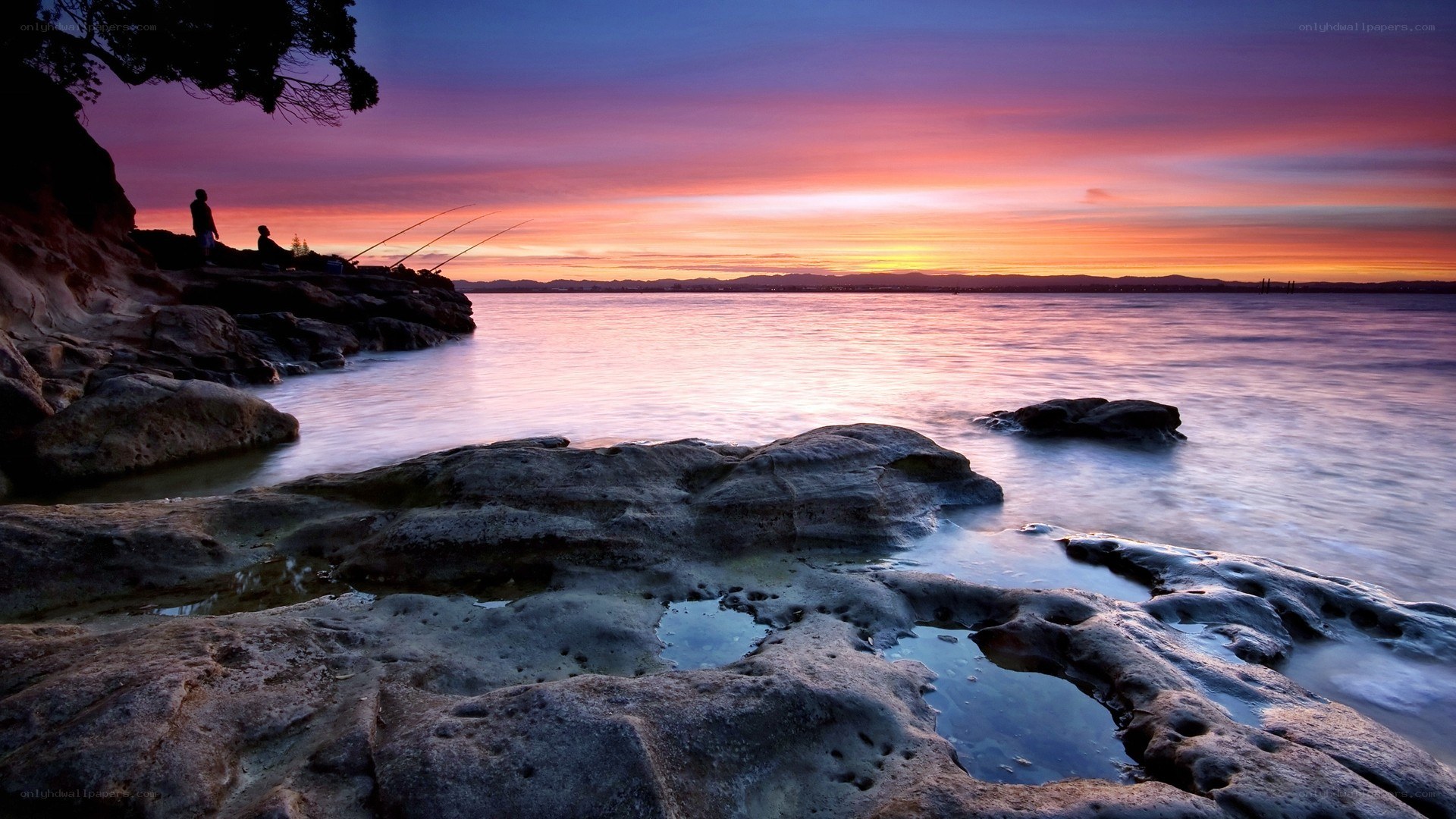 Sunset over rocky coastline
