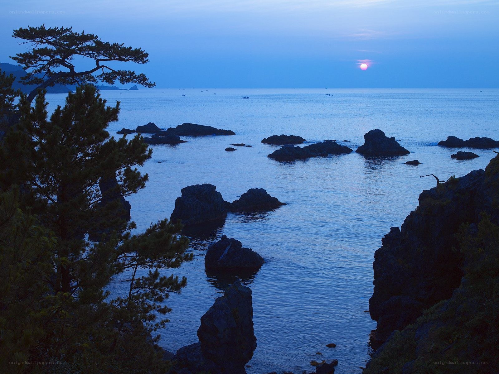 Sunset over rocky coastline