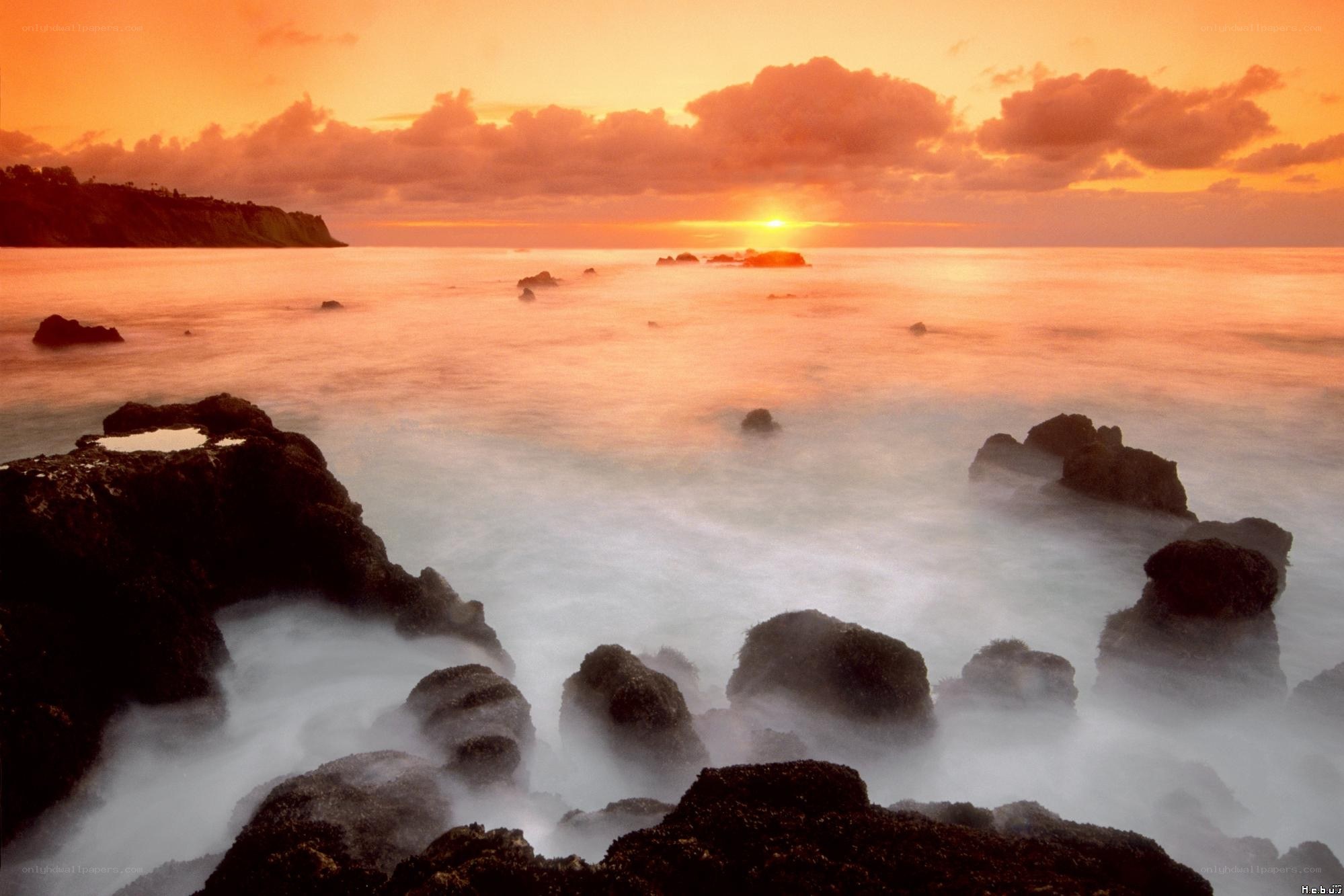 Sunset over rocky coastline