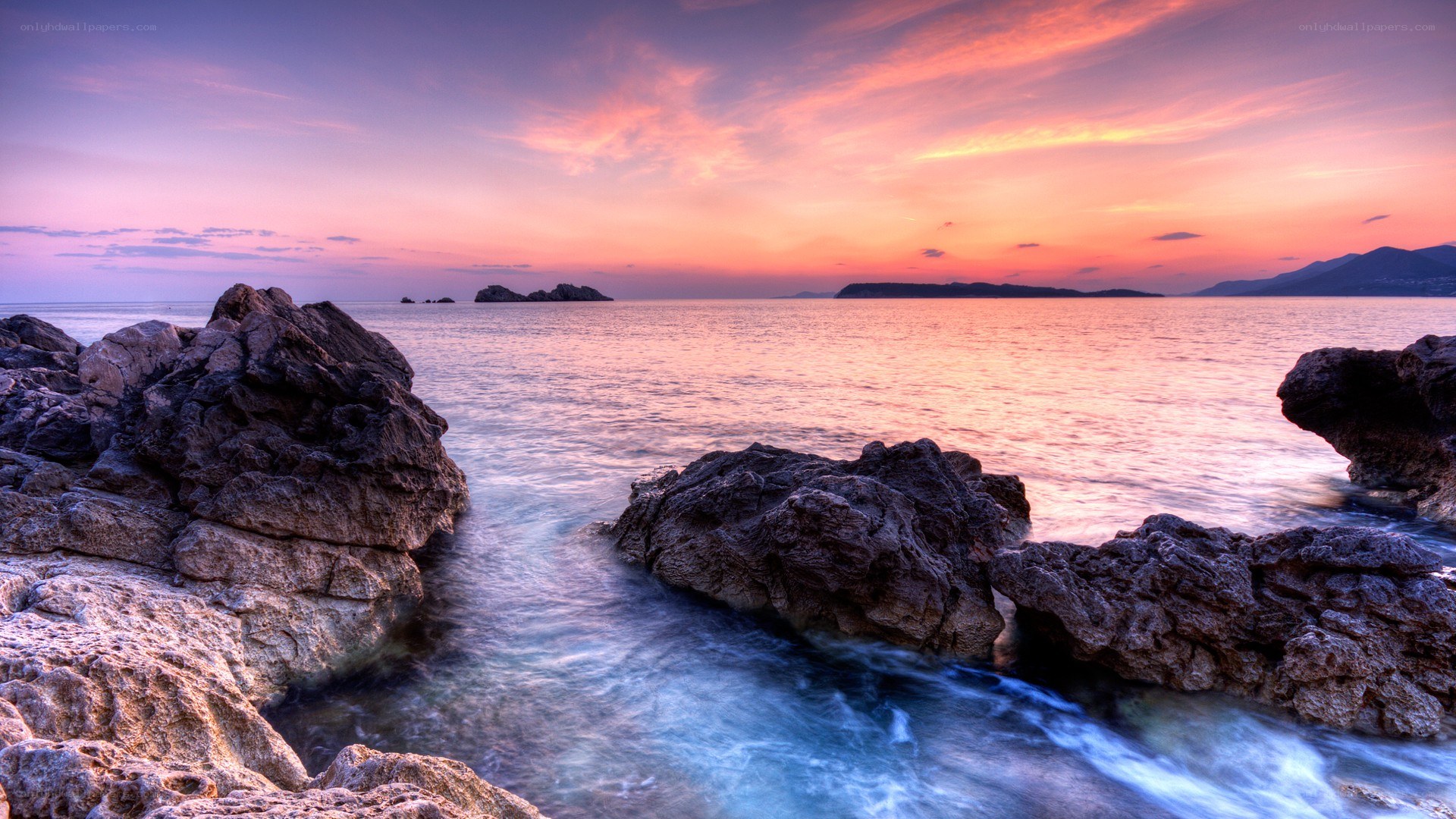 Sunset over rocky coastline