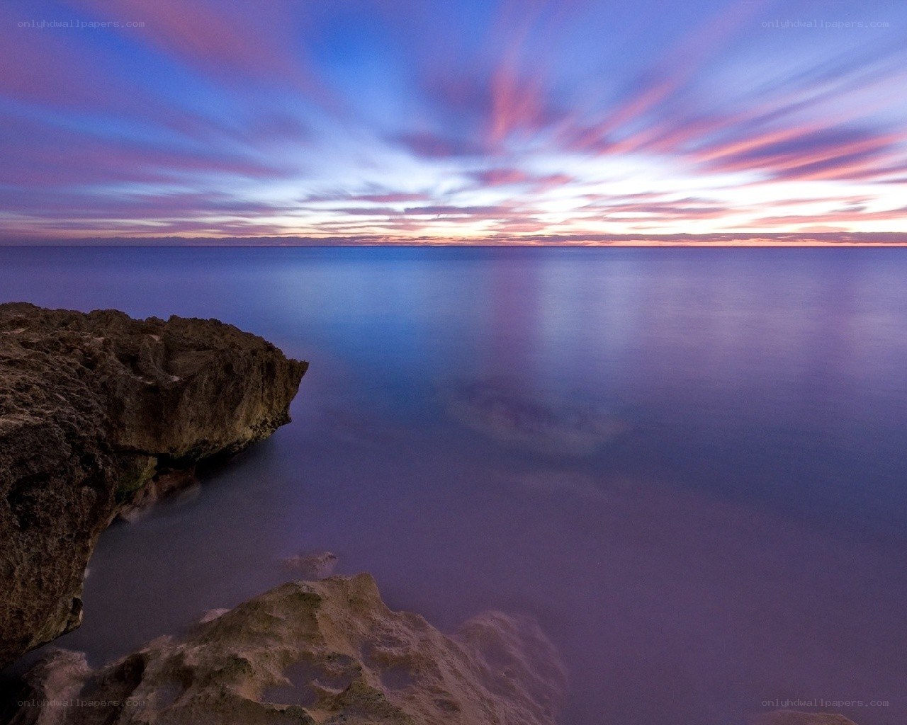 Sunset over rocky coastline