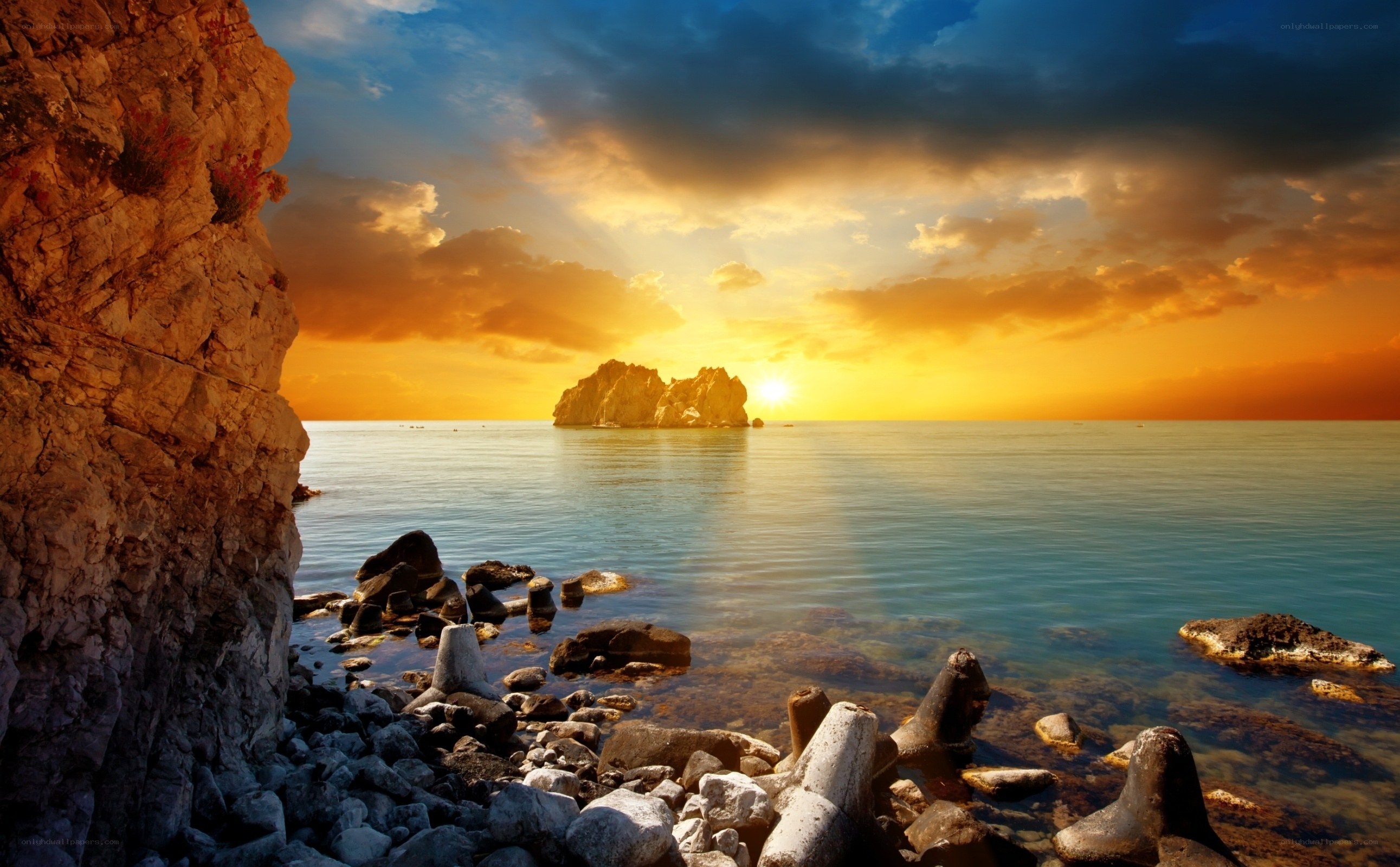 Sunset over rocky coastline
