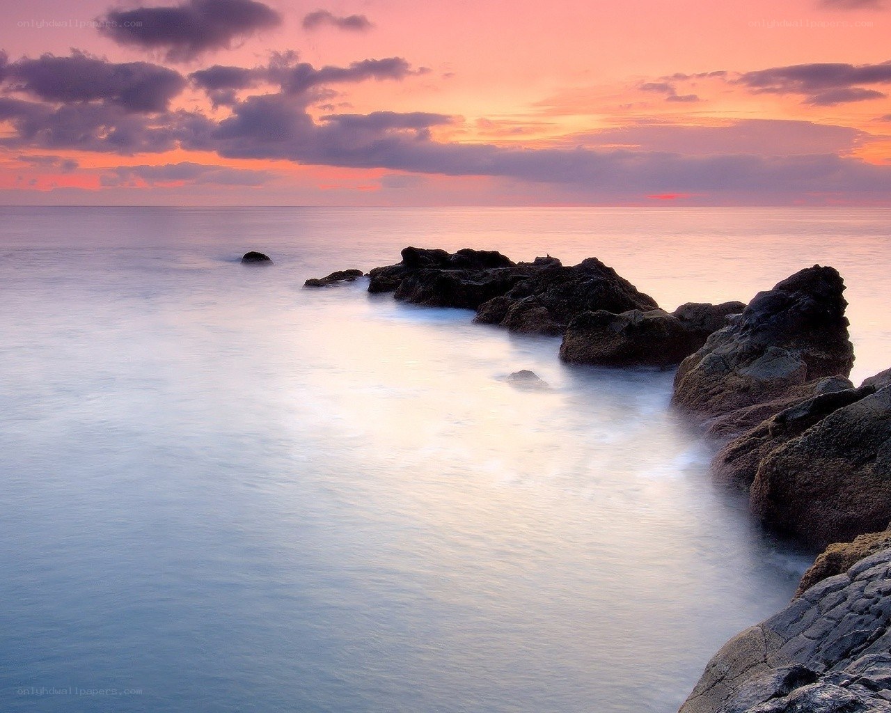 Sunset over rocky coastline