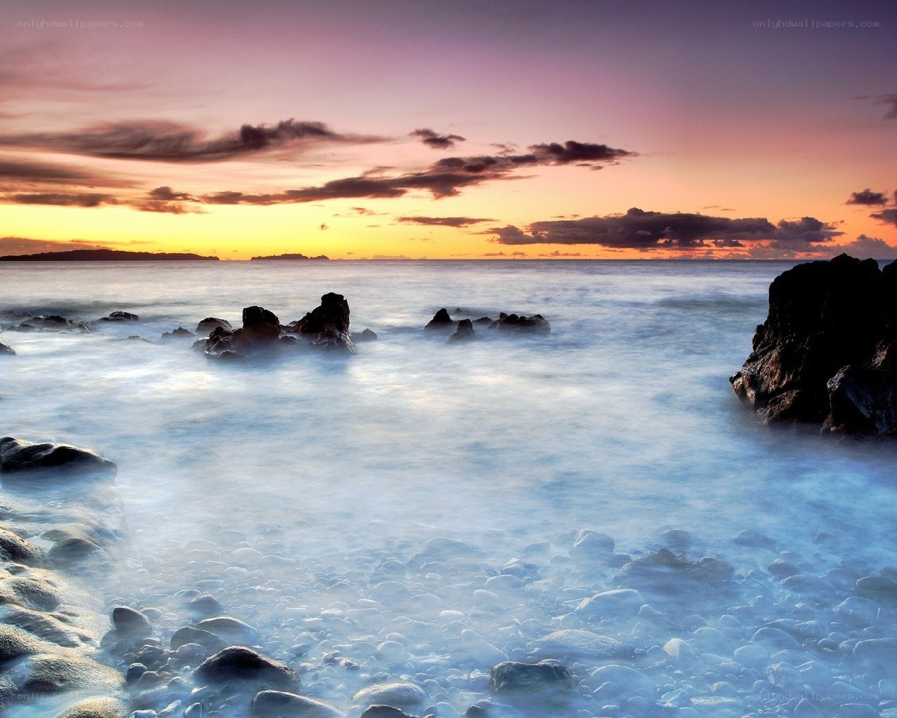 Sunset over rocky coastline