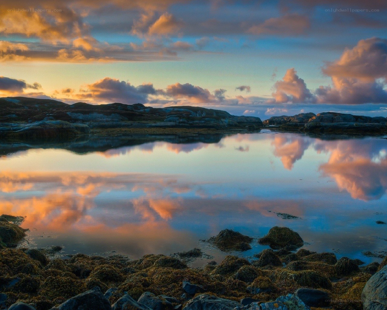 Sunset over rocky coastline