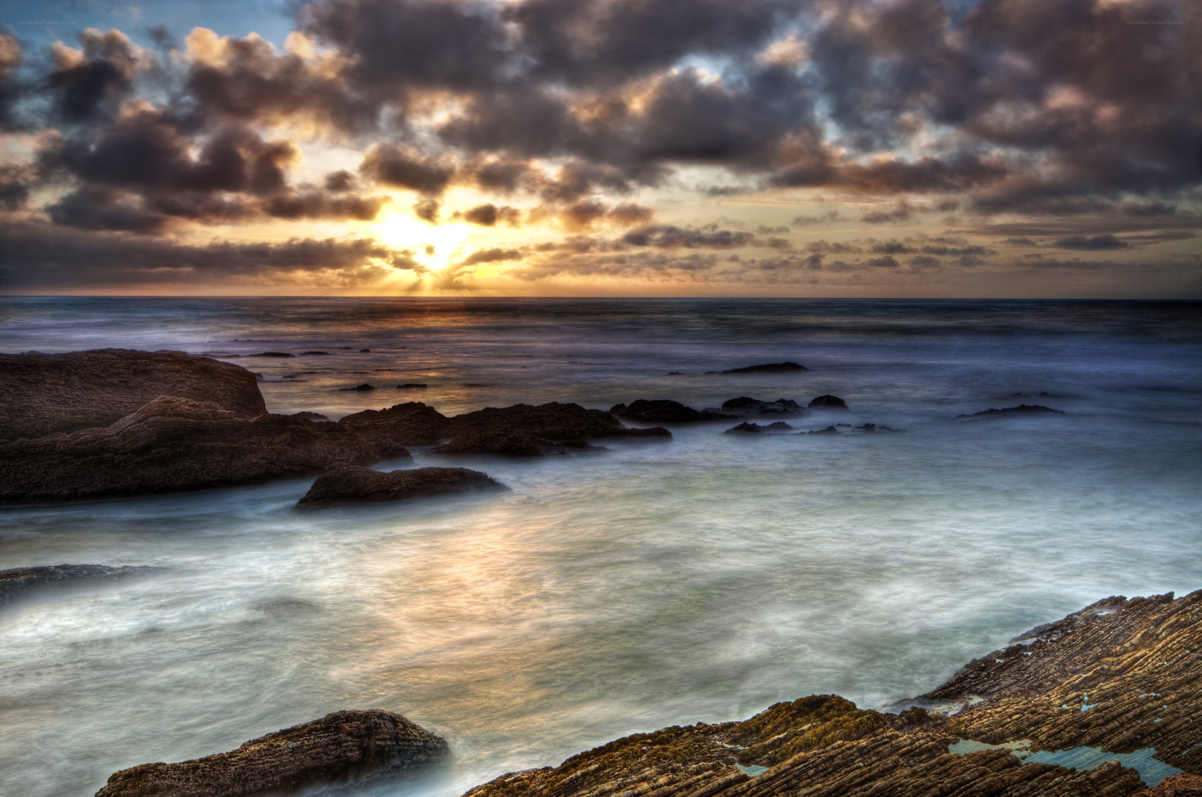 Sunset over rocky coastline