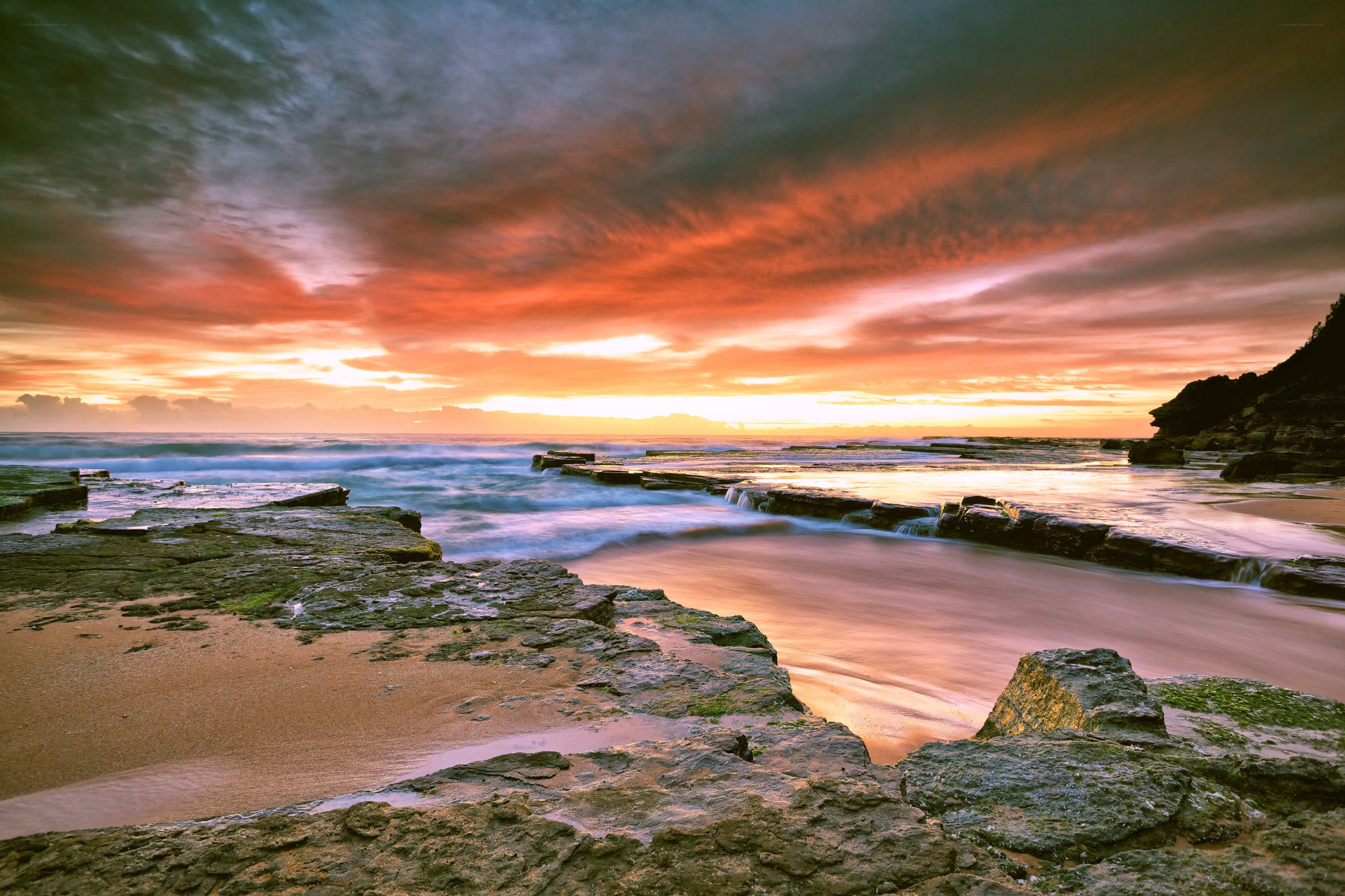 Sunset over rocky coastline