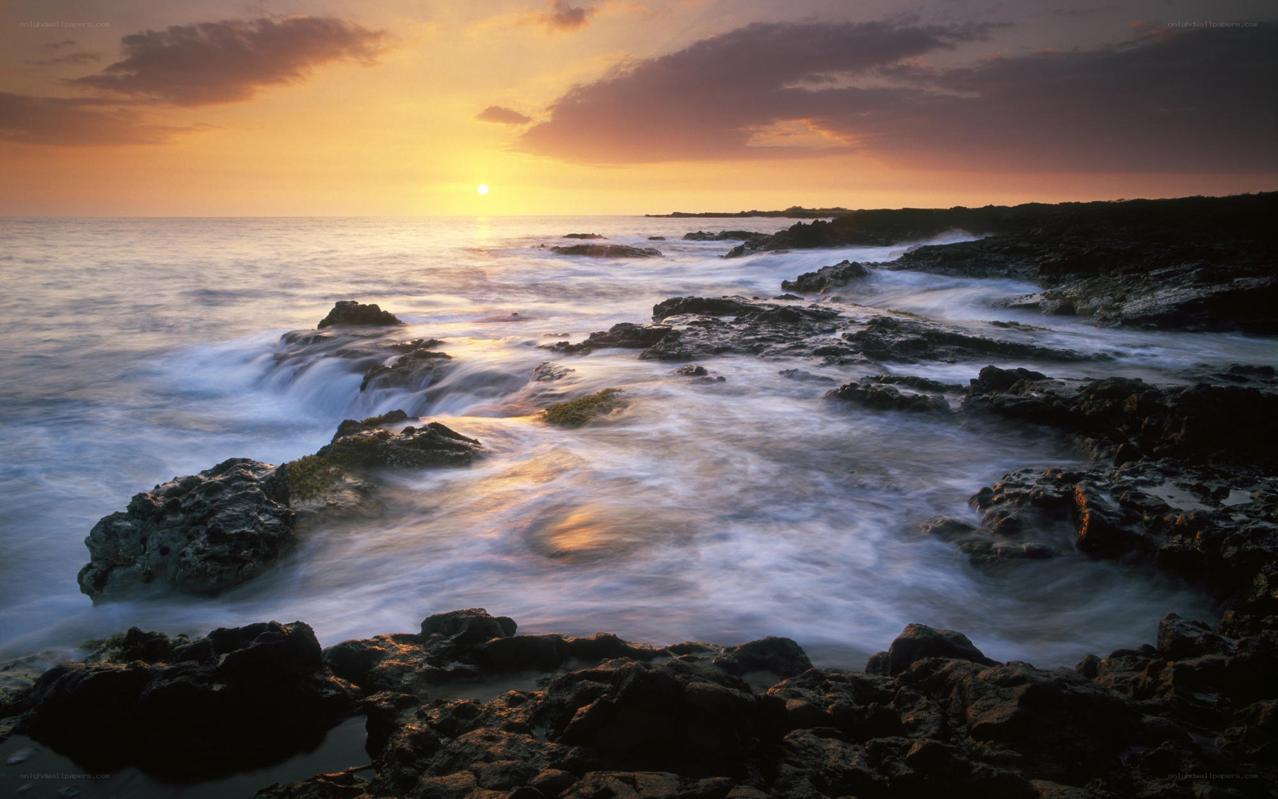 Sunset over rocky coastline