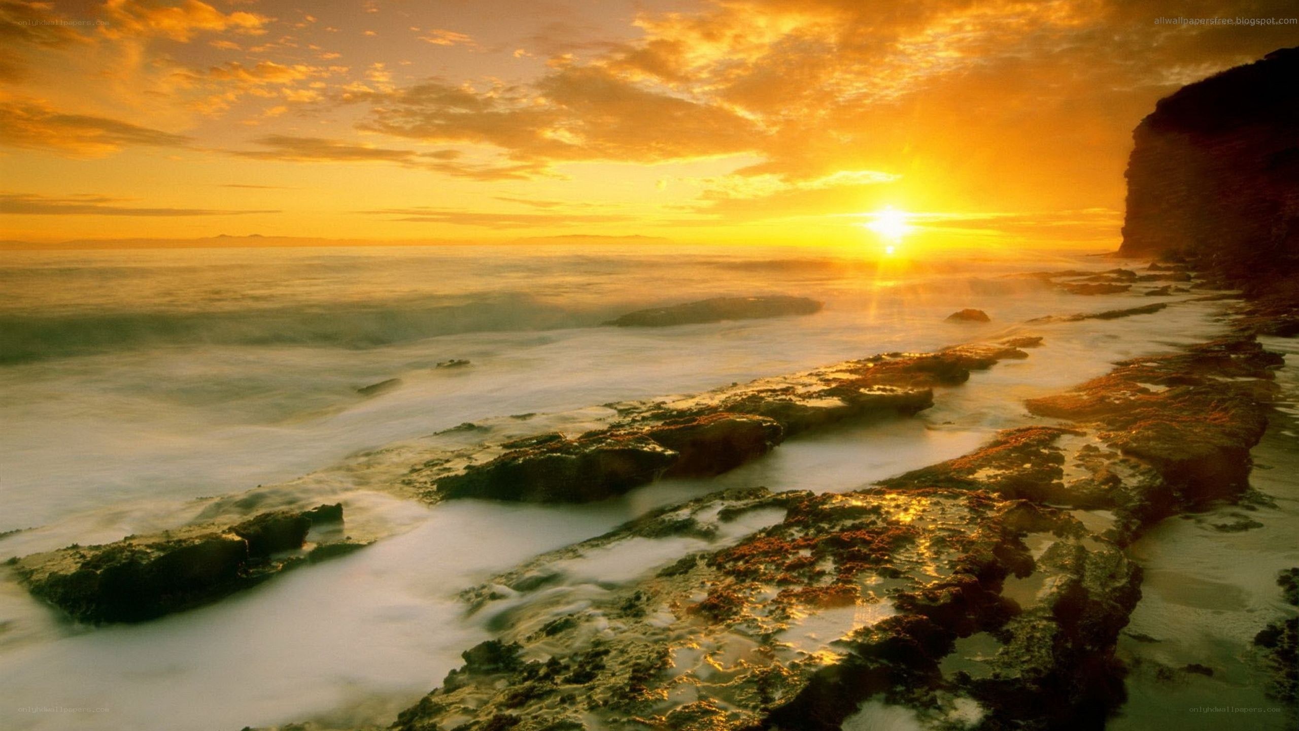 Sunset over rocky coastline