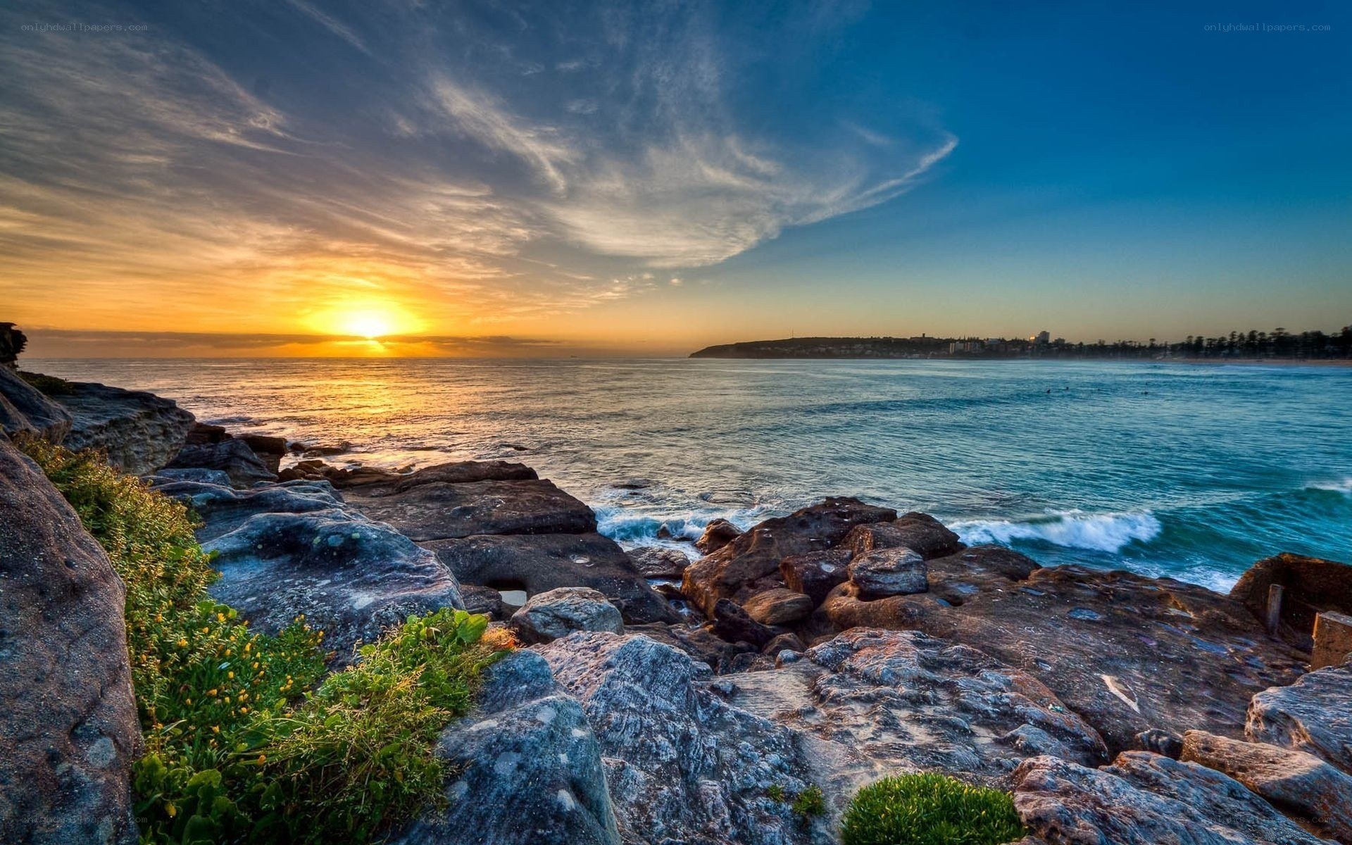 Sunset over rocky coastline