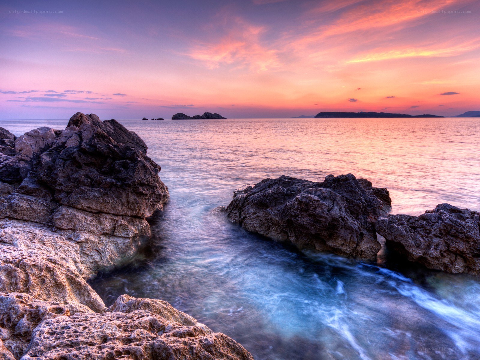 Sunset over rocky coastline