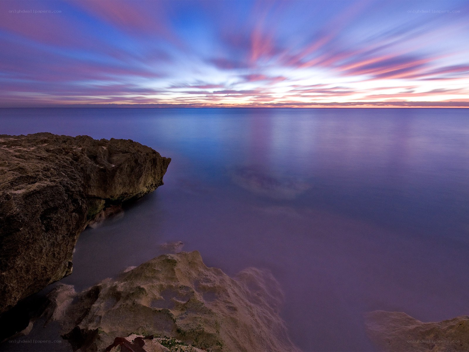 Sunset over rocky coastline