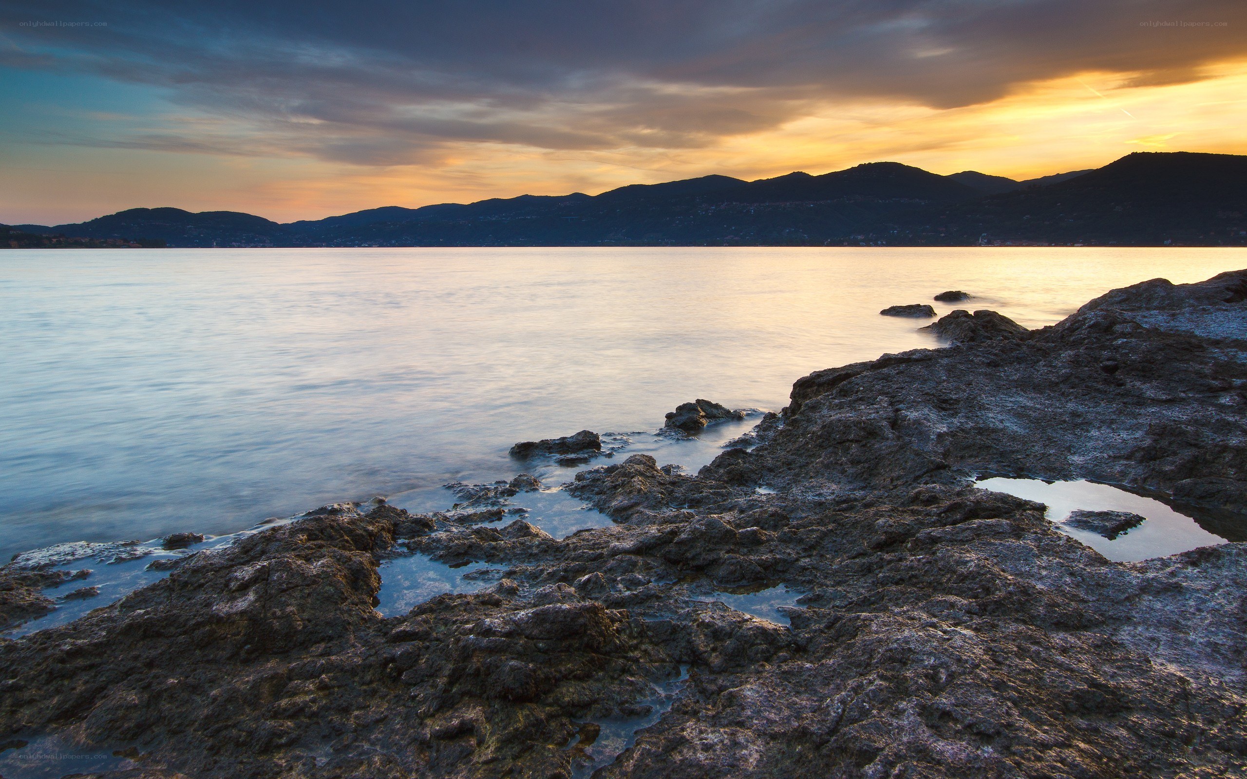 Sunset over rocky coastline