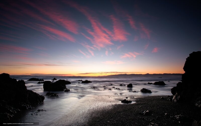 Sunset over rocky coastline