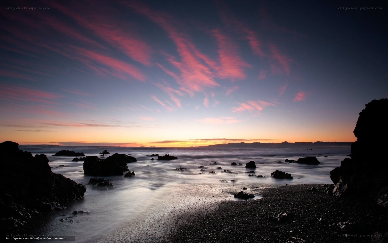 Sunset over rocky coastline