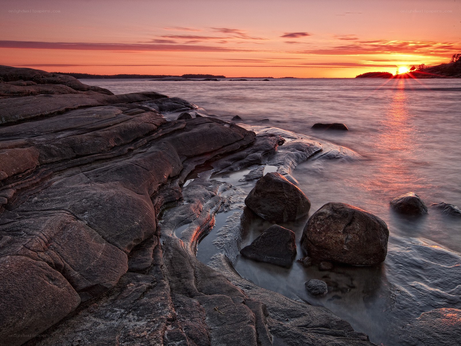 Sunset over rocky coastline