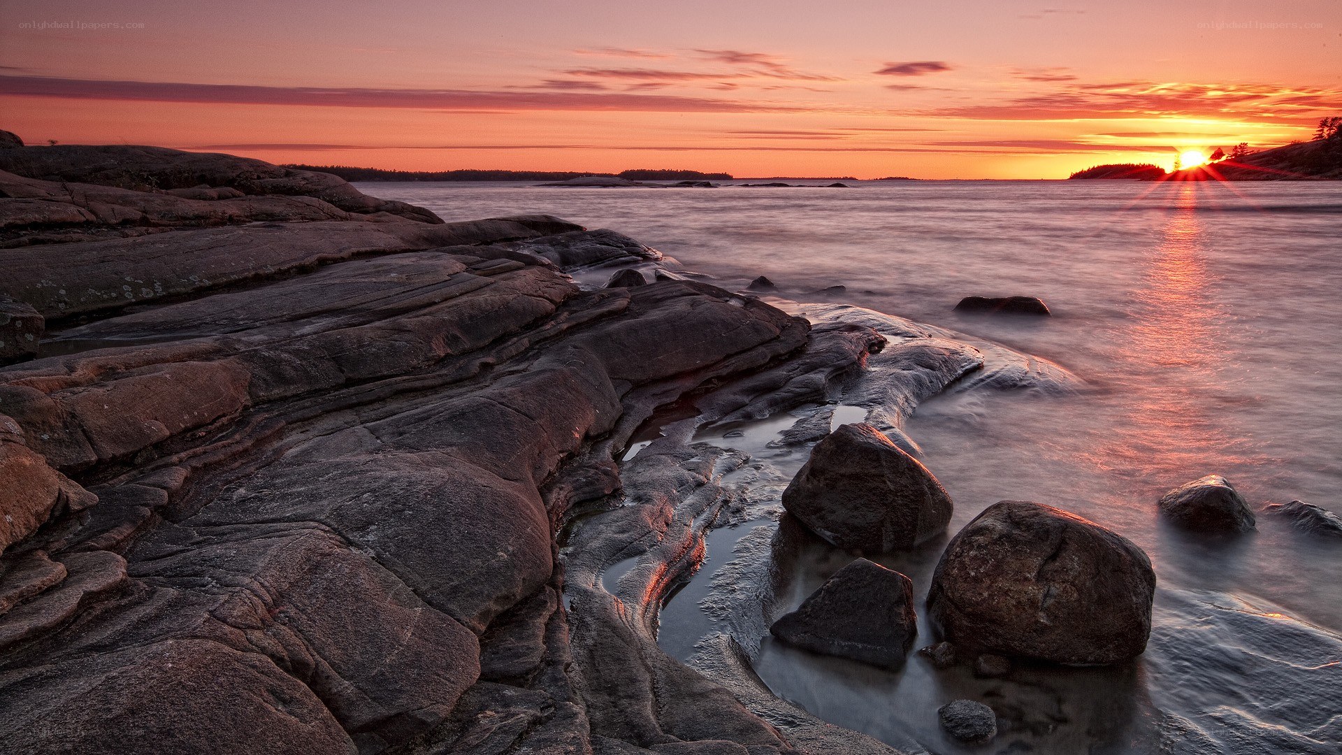 Sunset over rocky coastline