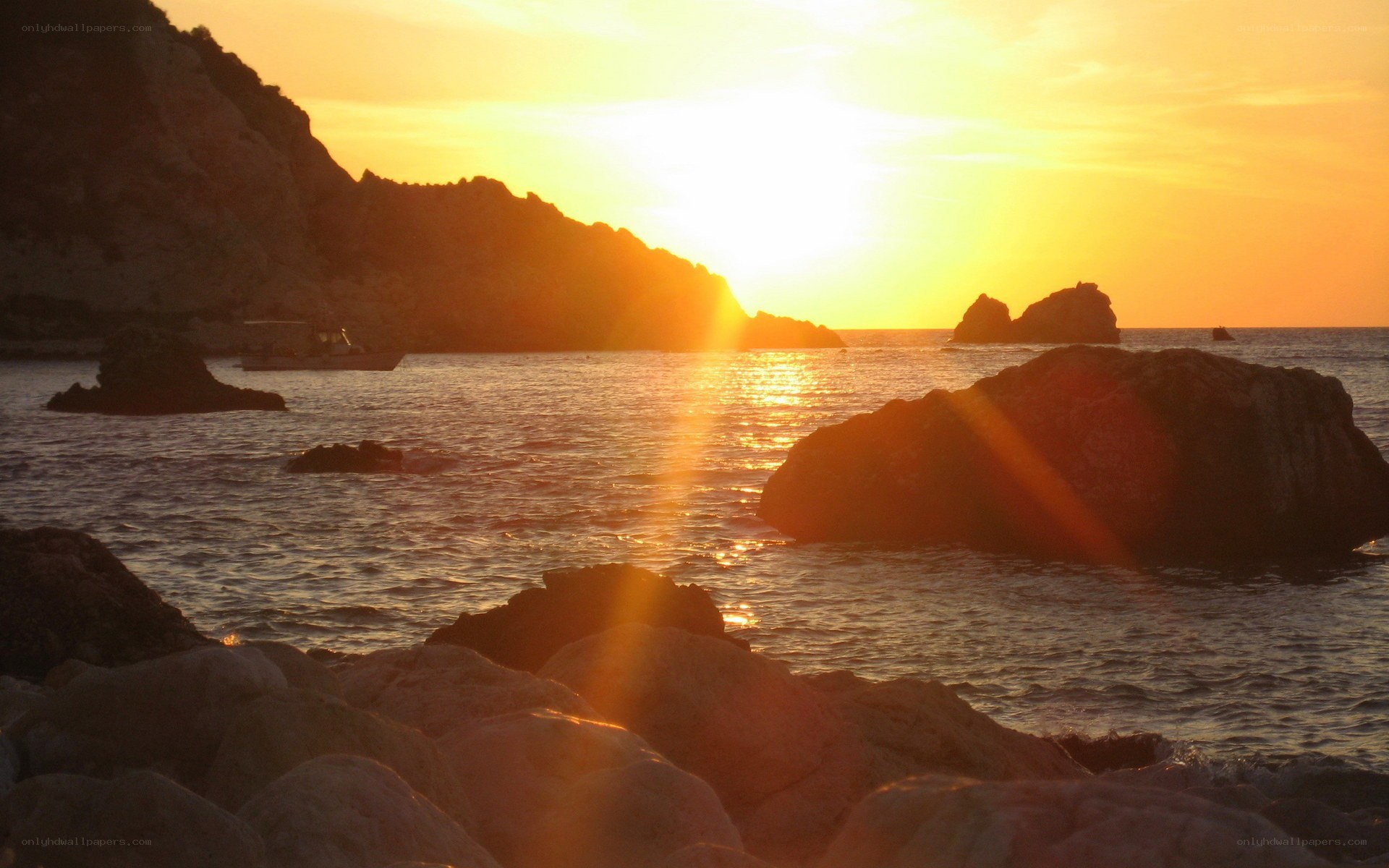 Sunset over rocky coastline