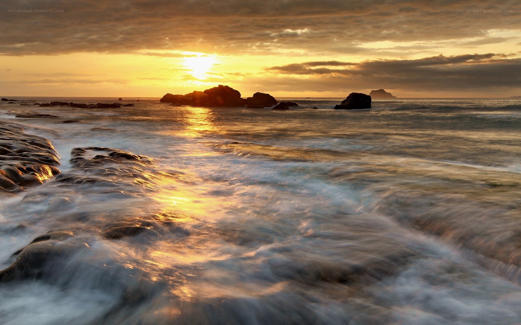 Sunset over rocky coastline