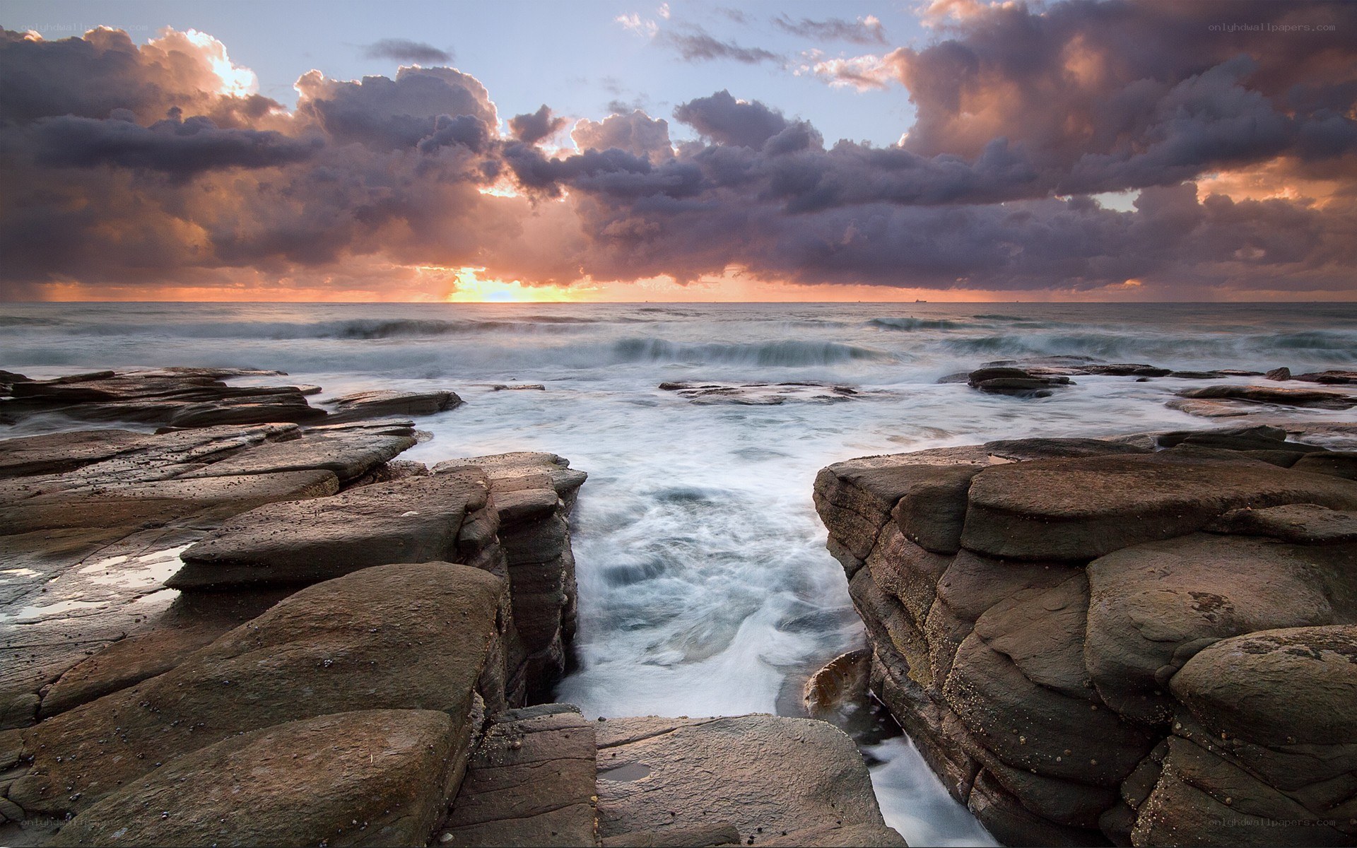 Sunset over rocky coastline