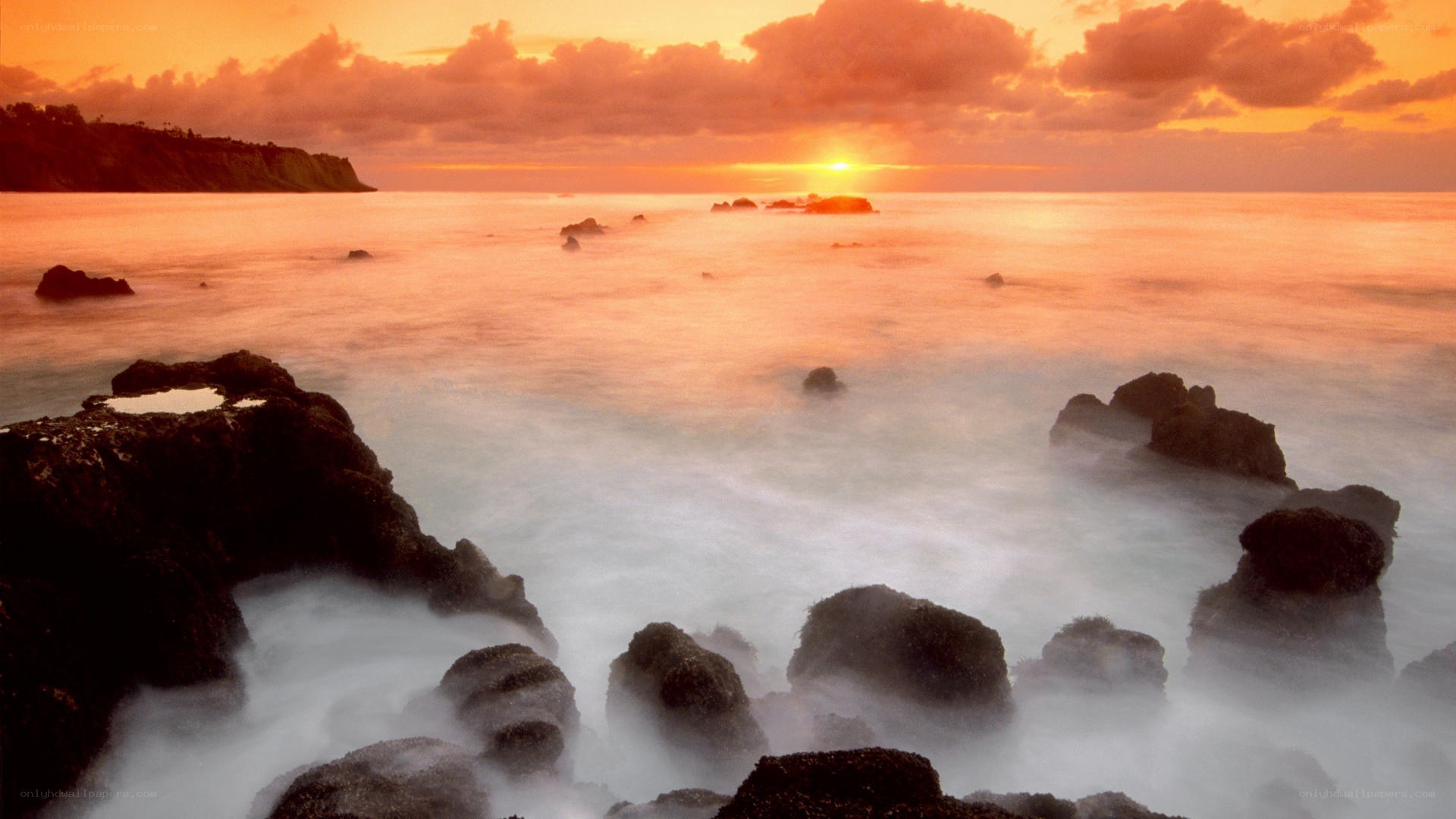 Sunset over rocky coastline
