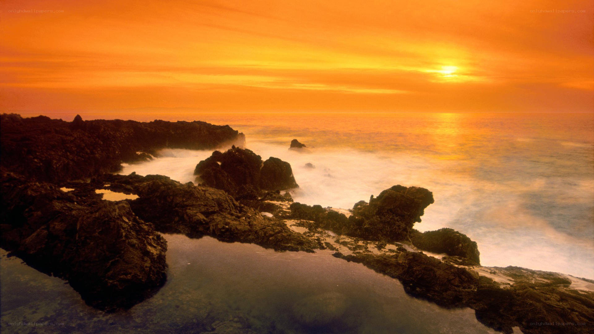 Sunset over rocky coastline
