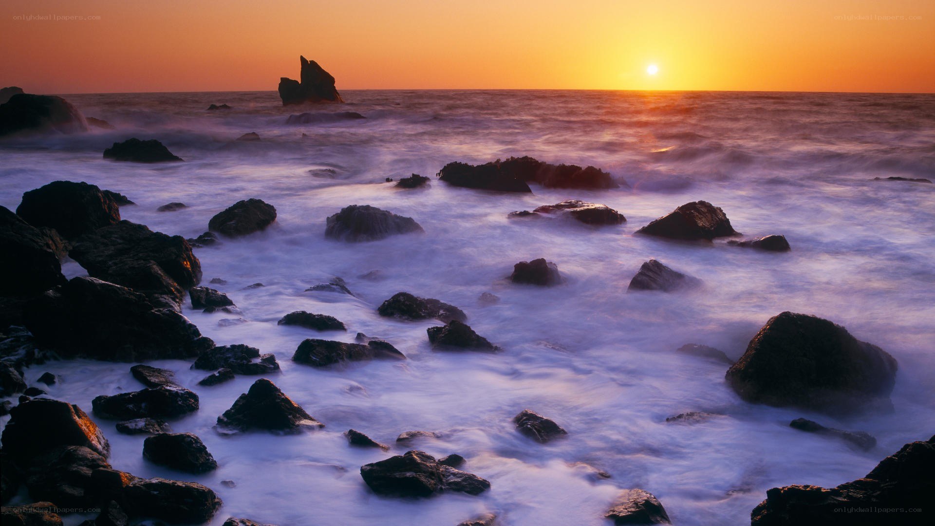 Sunset over rocky coastline