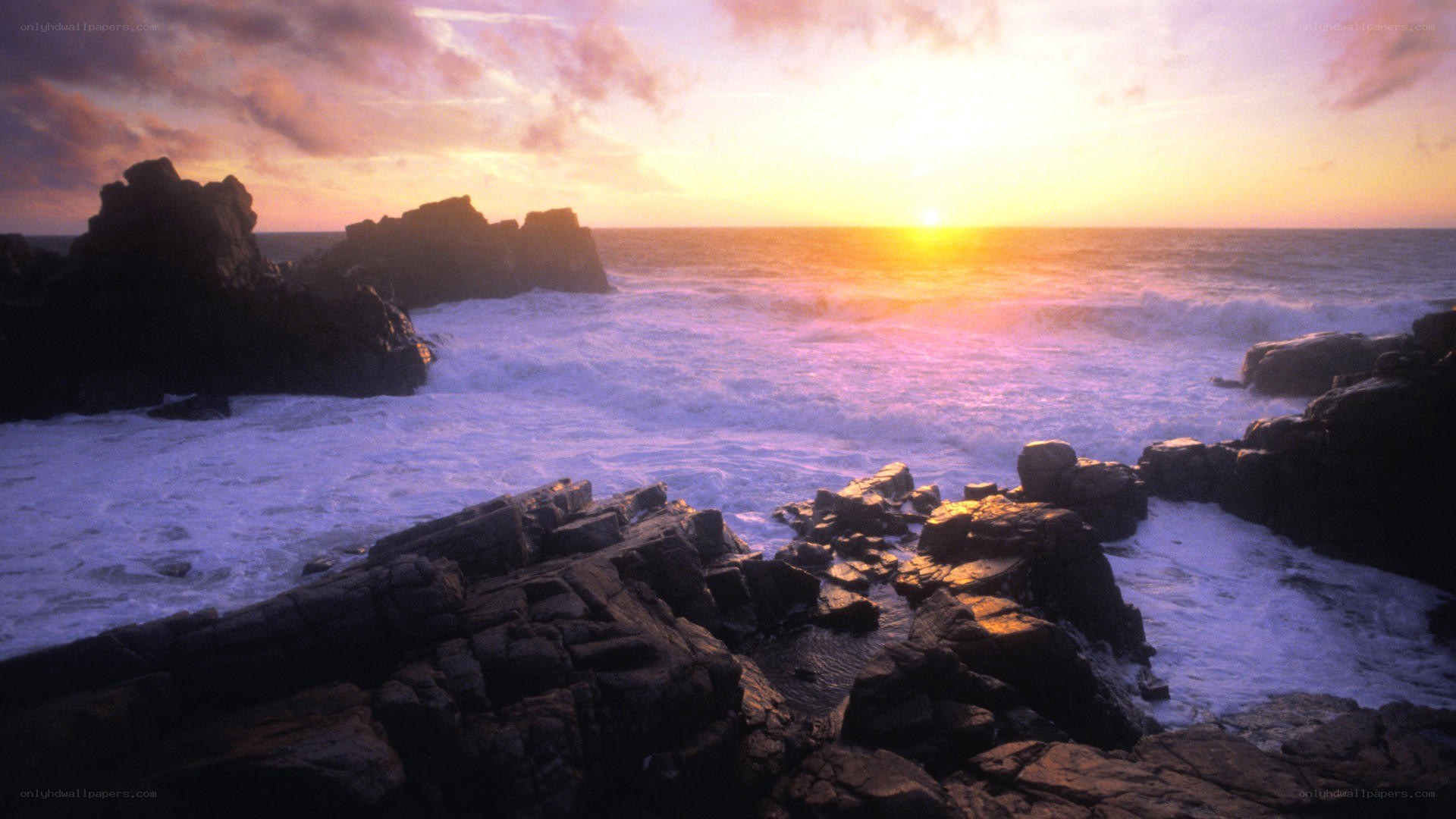 Sunset over rocky coastline