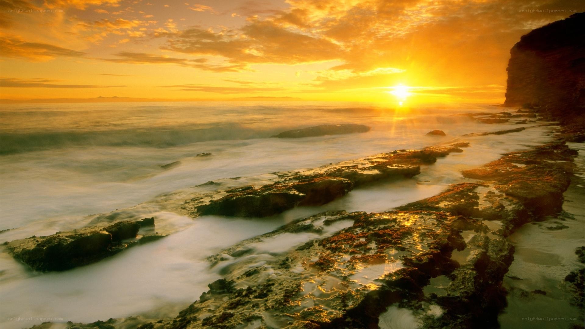 Sunset over rocky coastline