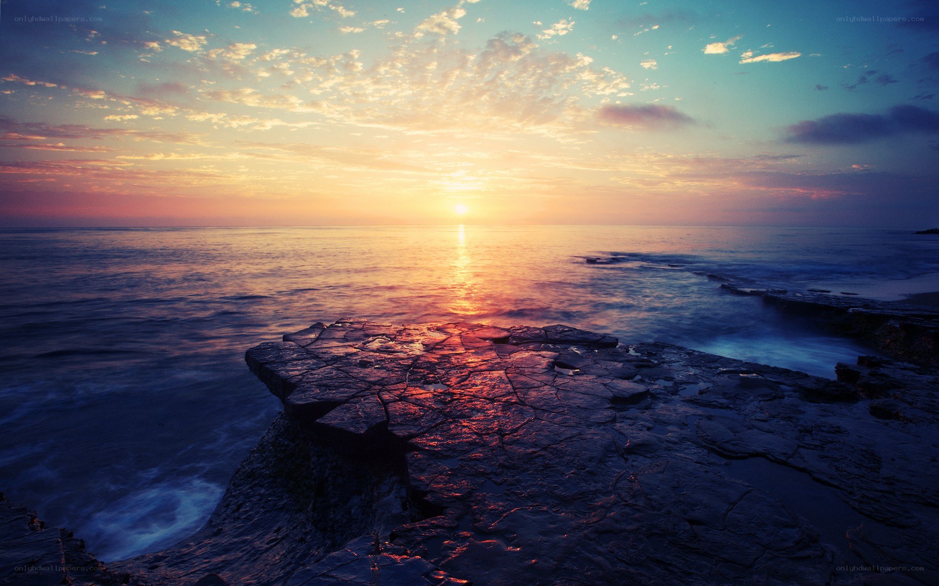 Sunset over rocky coastline