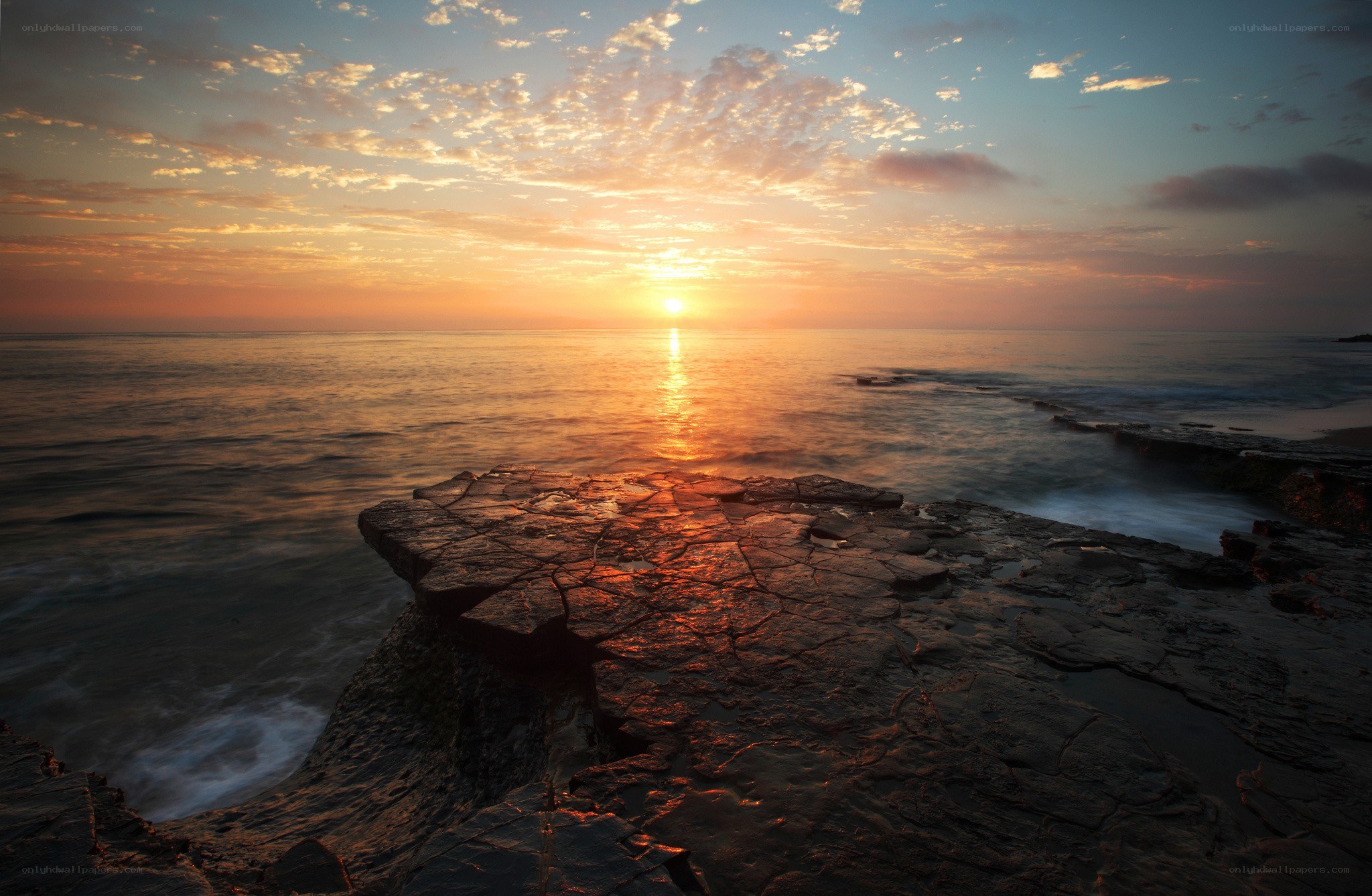 Sunset over rocky coastline