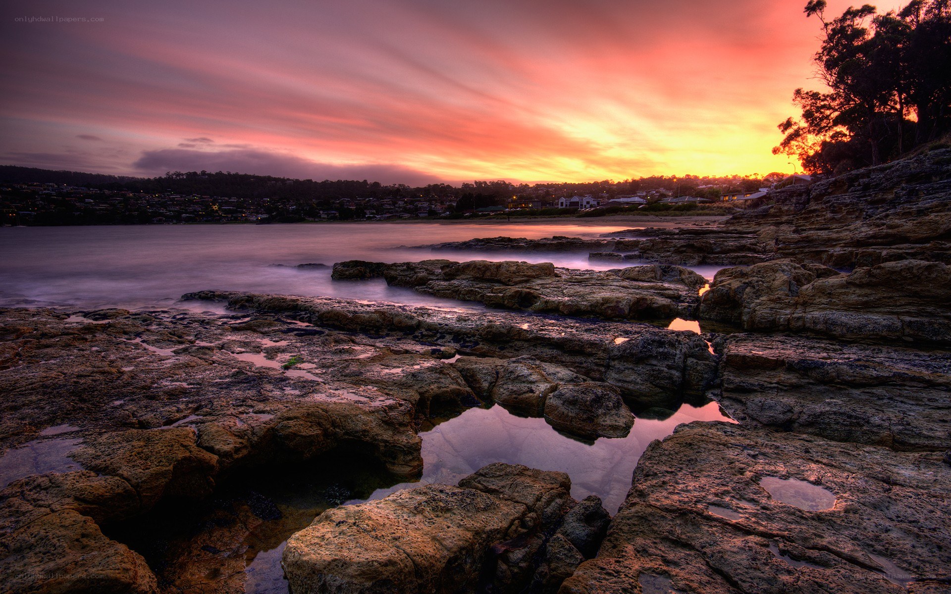 Sunset over rocky coastline