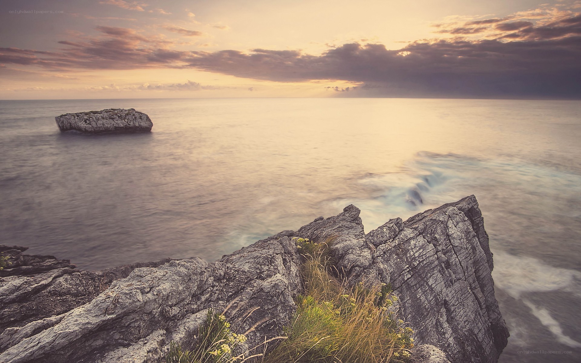 Sunset over rocky coastline