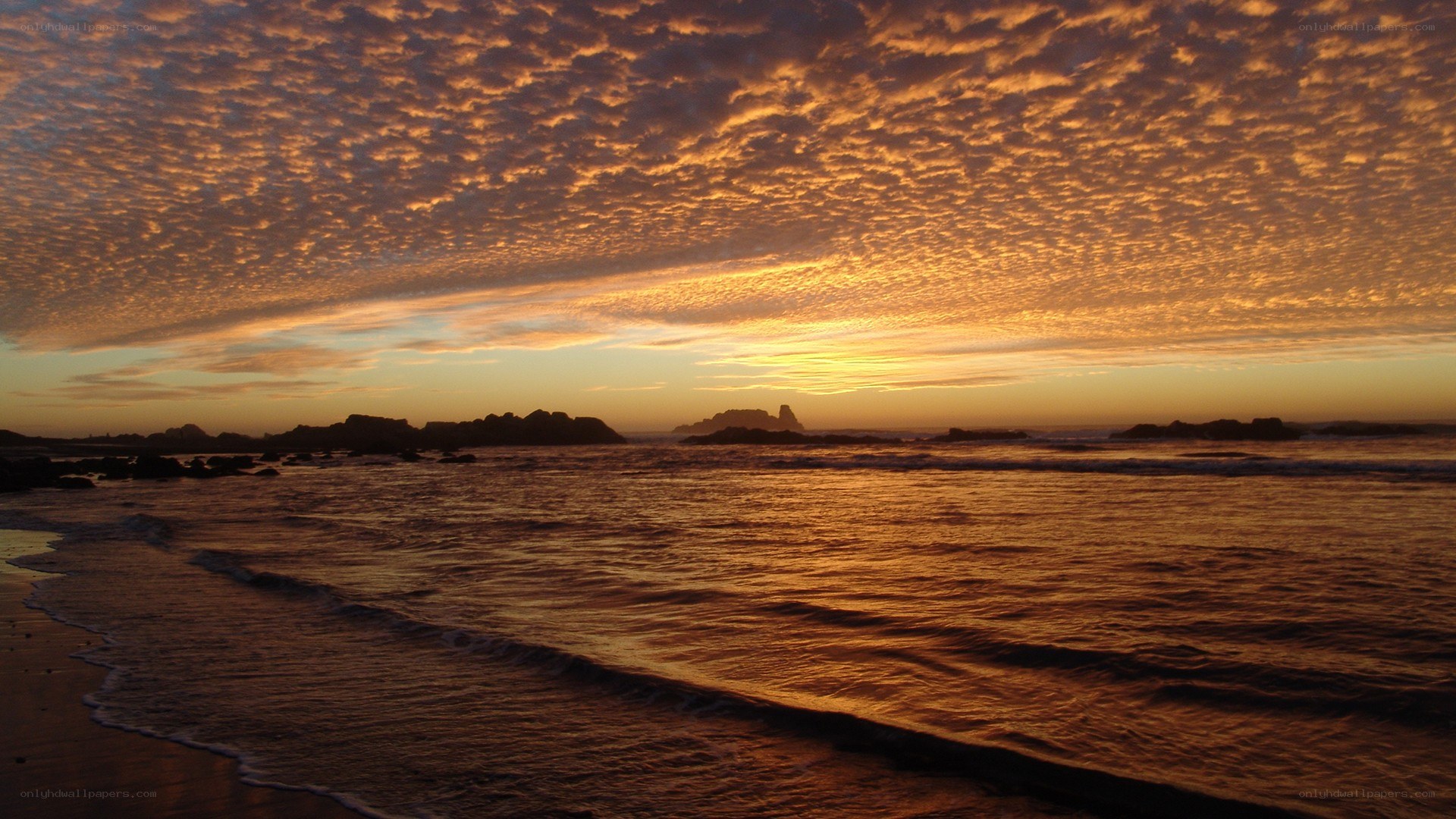 Sunset over rocky coastline