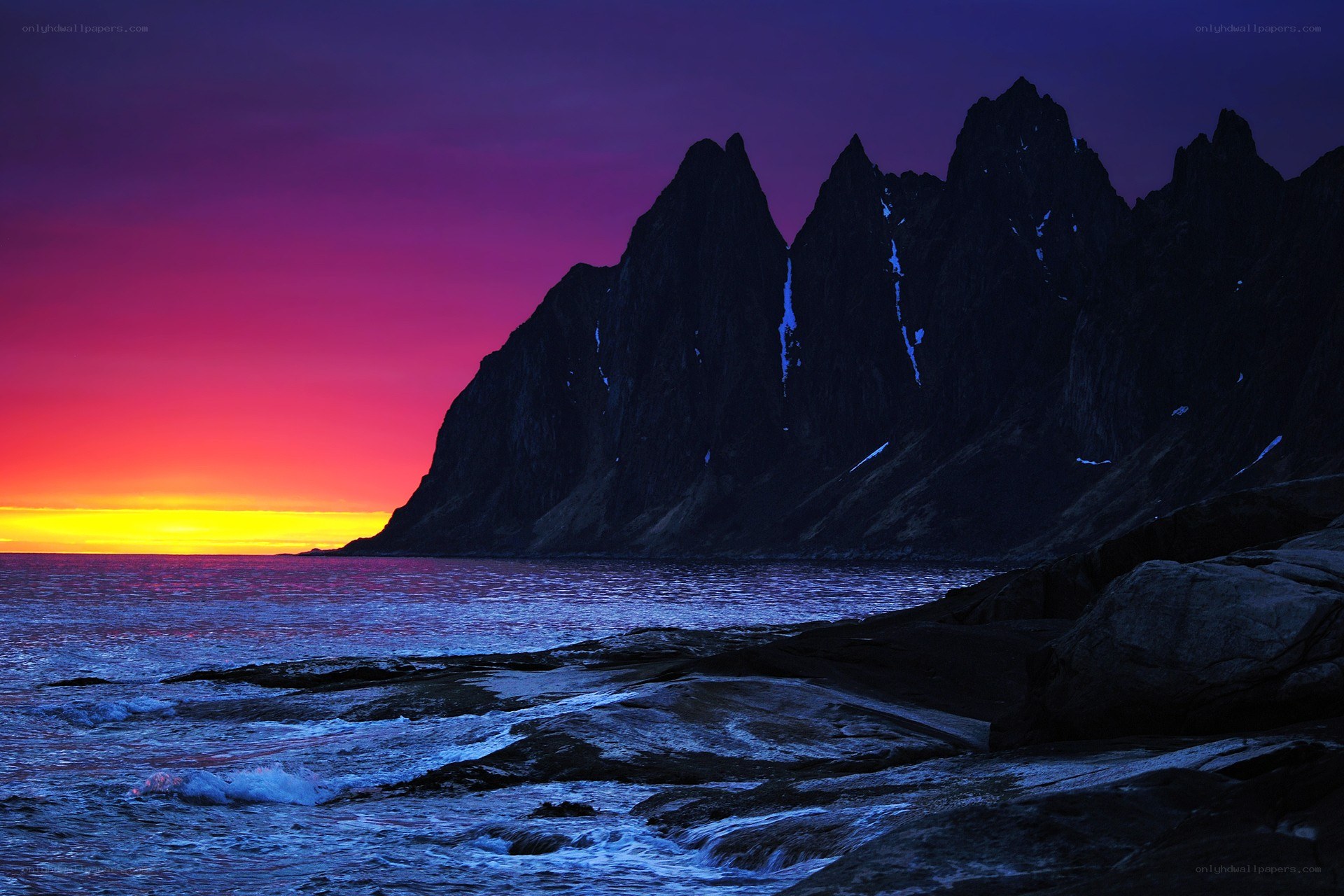 Sunset over rocky coastline