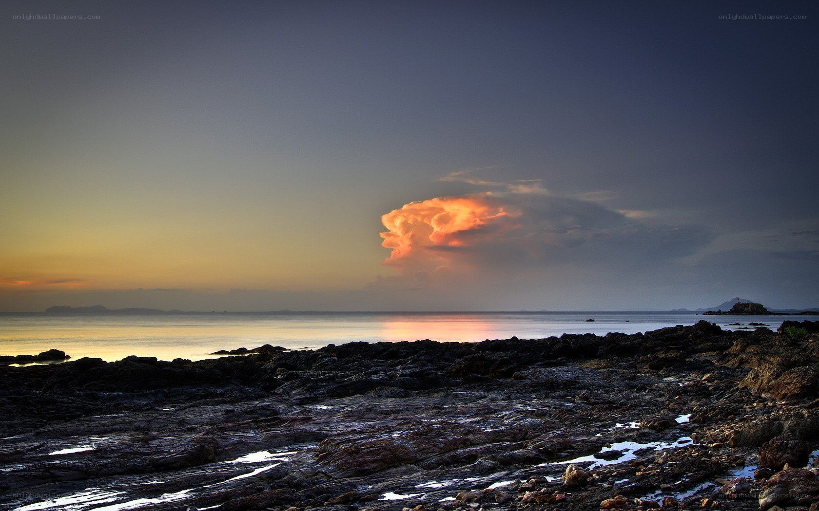Sunset over rocky coastline