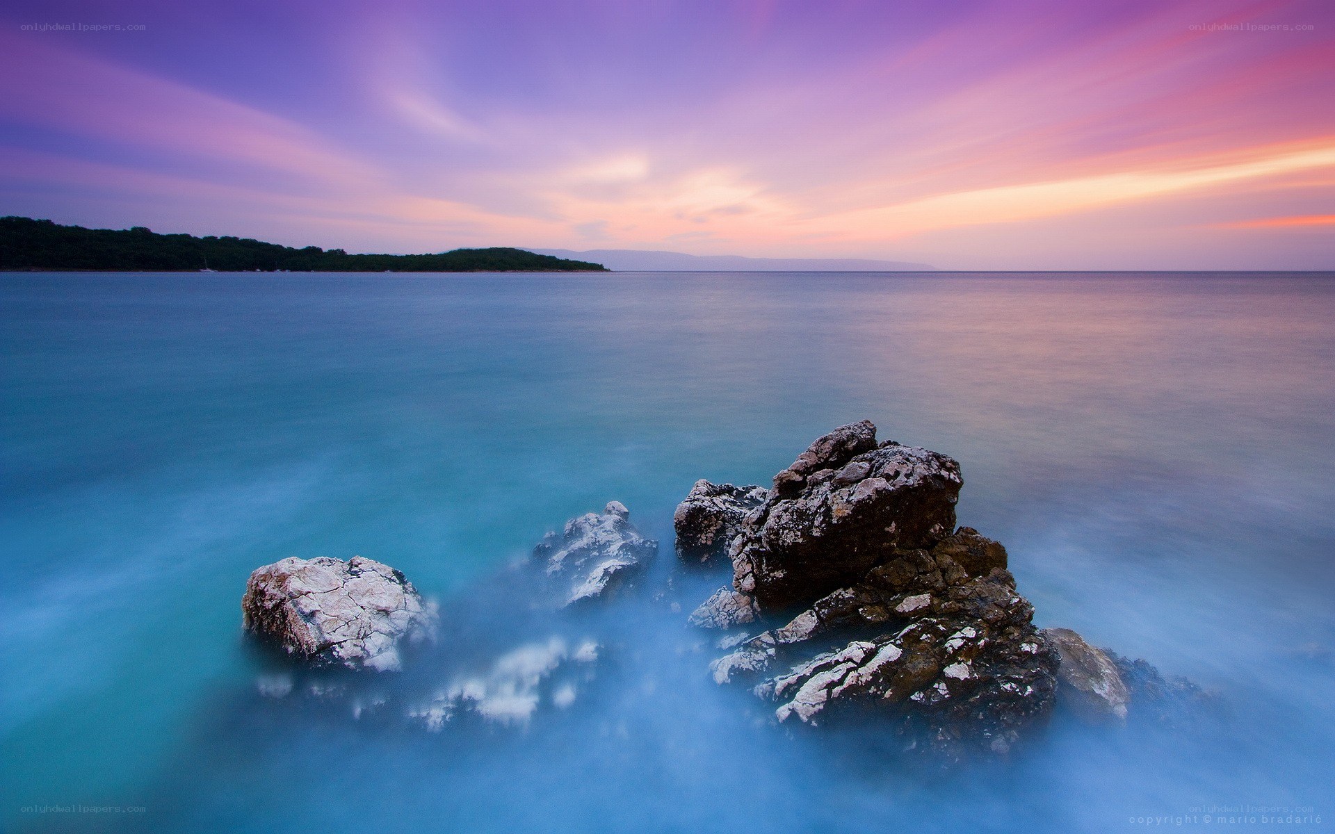 Sunset over rocky coastline