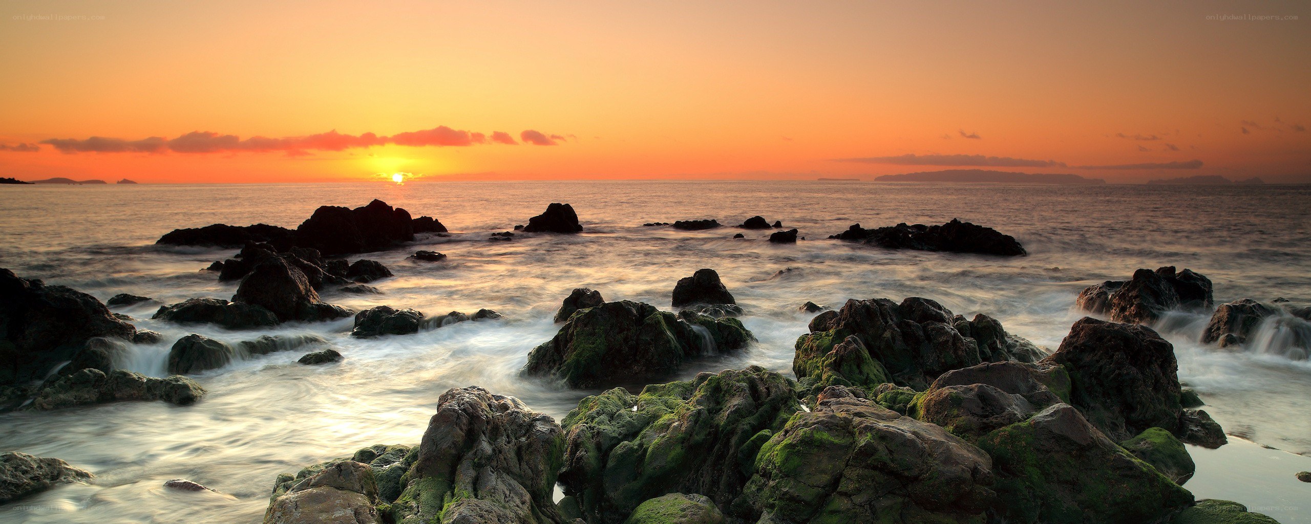 Sunset over rocky coastline