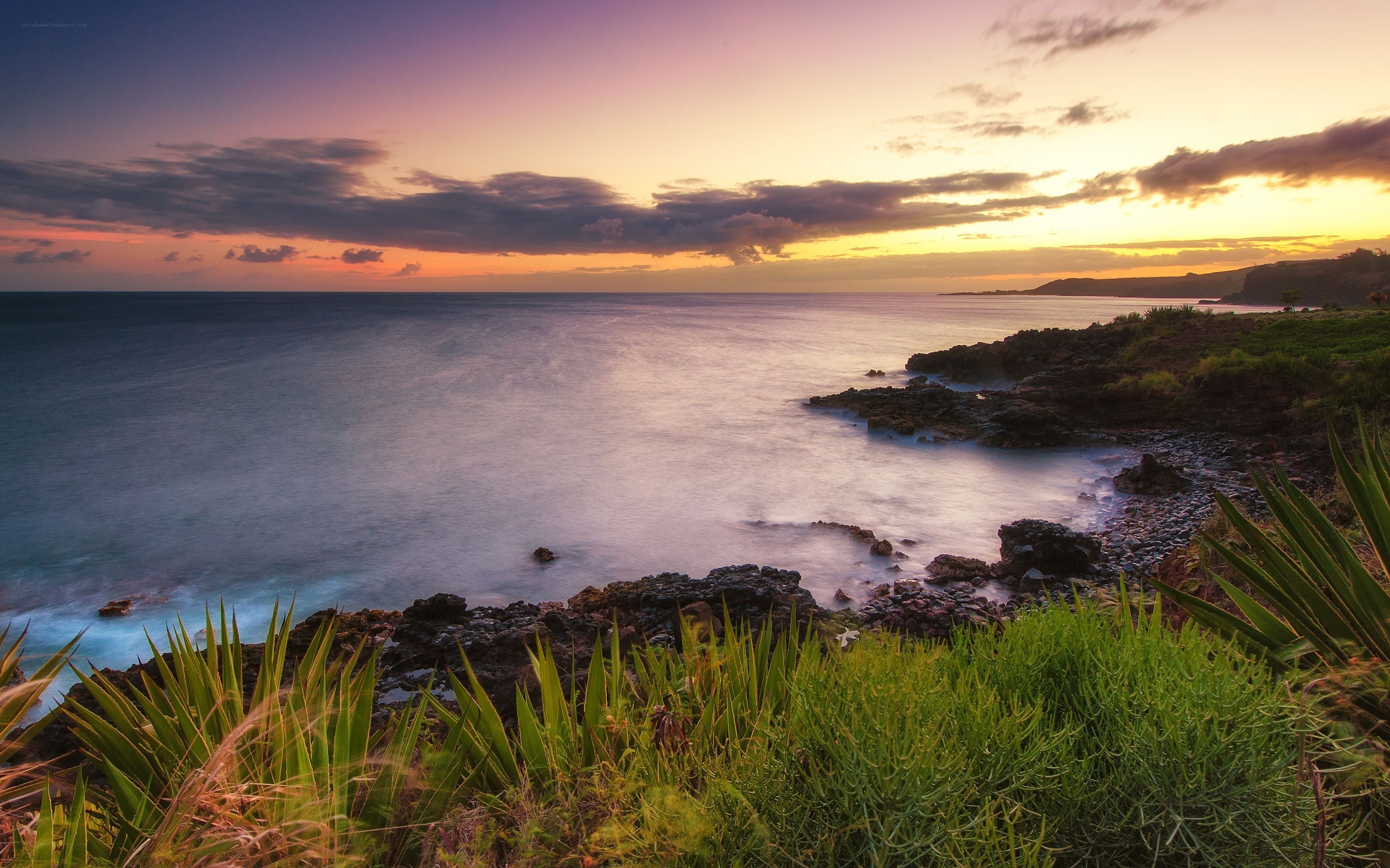 Sunset over rocky coastline
