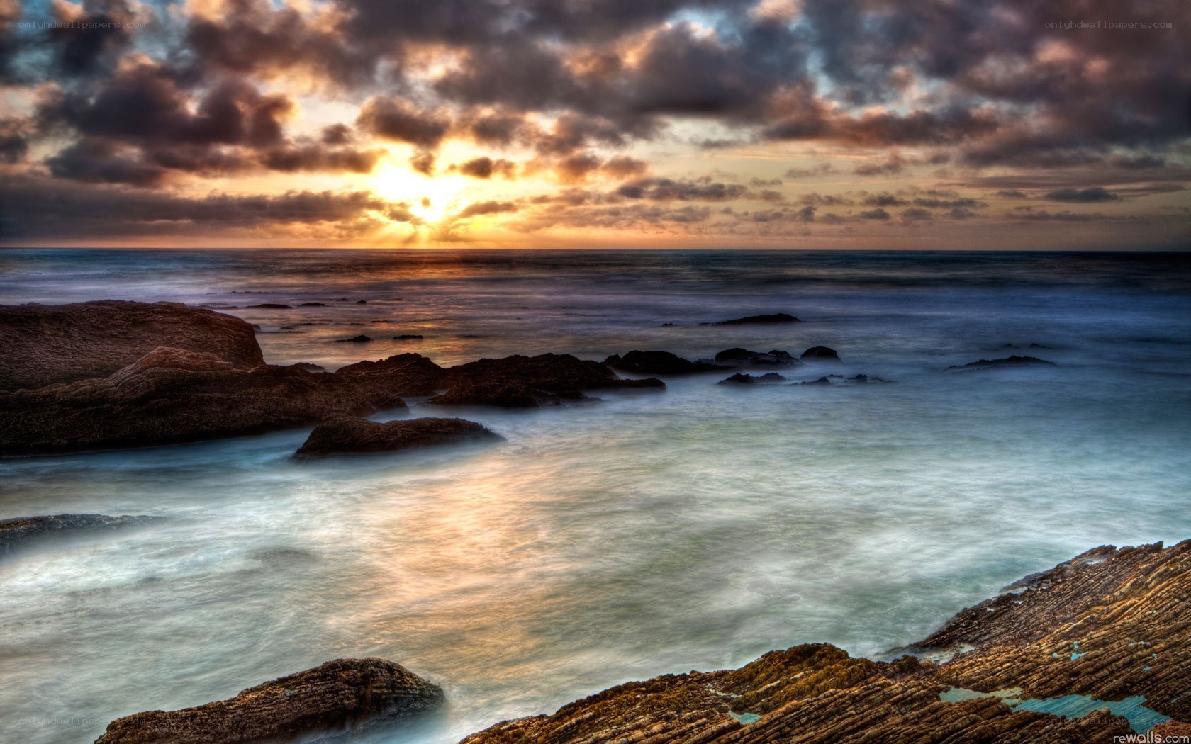 Sunset over rocky coastline