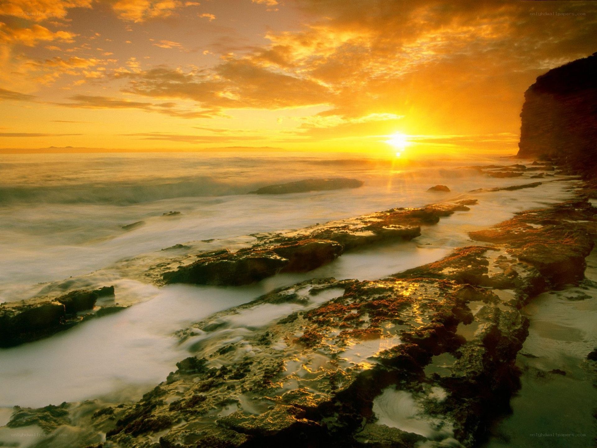 Sunset over rocky coastline